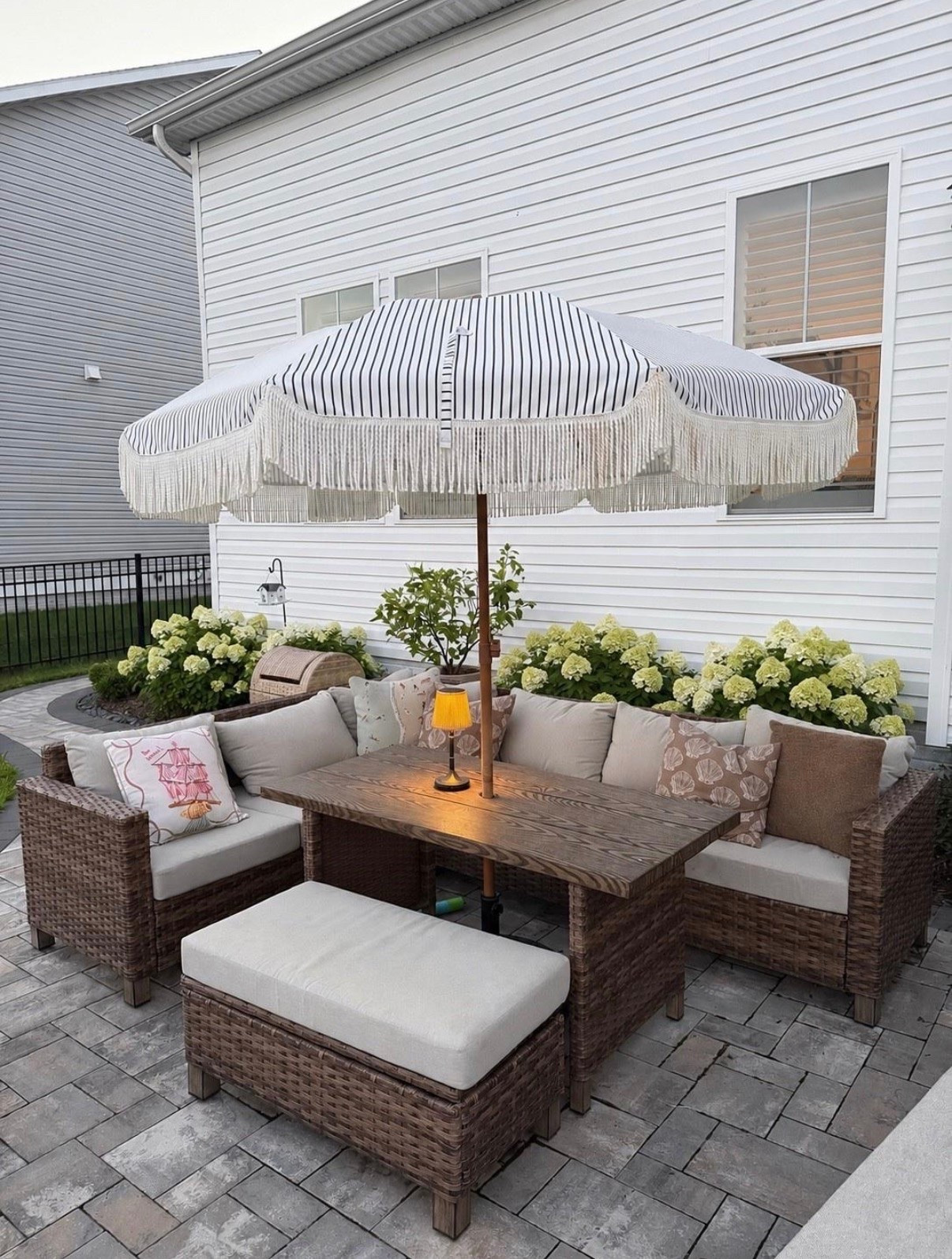The patio upgrade that completely changed the space. 🤍 From the striped fringe umbrella to the cozy wicker seating, every piece makes this backyard feel like a boutique hotel. Proof you don’t need a huge budget to create an outdoor space you’ll never want to leave.

patio furniture, outdoor living, backyard makeover, wicker patio set, striped patio umbrella, fringe umbrella, outdoor decor, backyard inspiration, patio styling, outdoor entertaining, cozy backyard, outdoor sectional, patio ideas, summer outdoor living.