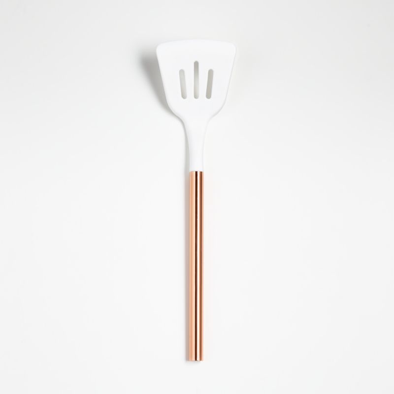 Ada White Silicone Slotted Turner with Copper Handle | Crate and Barrel | Crate & Barrel