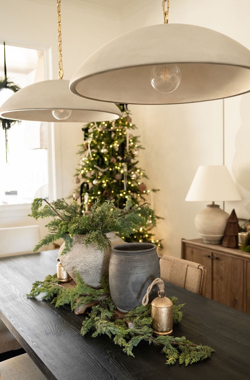 All the cozy Christmas textures in one space ✨ From the earthy centerpiece to the natural greenery, warm wood tones, and soft twinkle lights, this room leans into calm, collected holiday styling. Great for Christmas home inspiration, dining room Christmas ideas, organic winter decor, minimal holiday decorating, and neutral holiday accents. 🎄

#LTKHome #LTKHoliday #LTKSeasonal