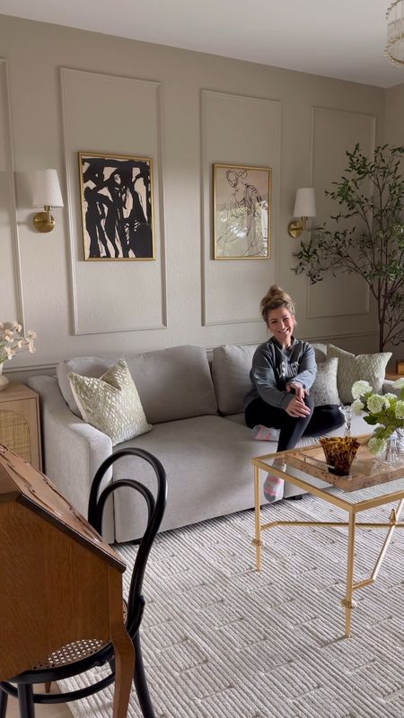 Lounge/flex/spare room decor reveal! Including this ivory rug, French inspired gold coffee table, convertible sofa, tv console, corner arch oversized floor mirror, wall art, wireless sconces, olive tree, Burl wood side table, arch rattan cabinet, sheer curtains, and crystal light fixture!

#LTKstyletip #LTKsalealert #LTKhome