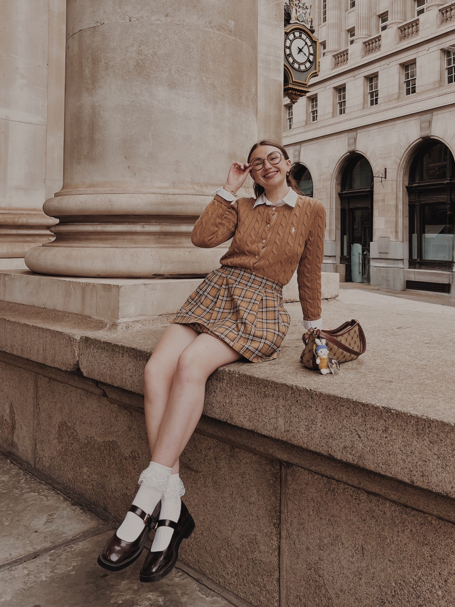 Brown cable knit cardigan
White poplin shirt
Plaid skort 
White socks with lace ruffels 
Brown Mary Janes 
Brown Patterned bag 

Light academia
Light academia outfit Light academia style Light academia aesthetic
Neutral outfit Autumn outfit
Autumn fashion
Autumn fashion inspo

#LTKFindsUnder50 #LTKSeasonal