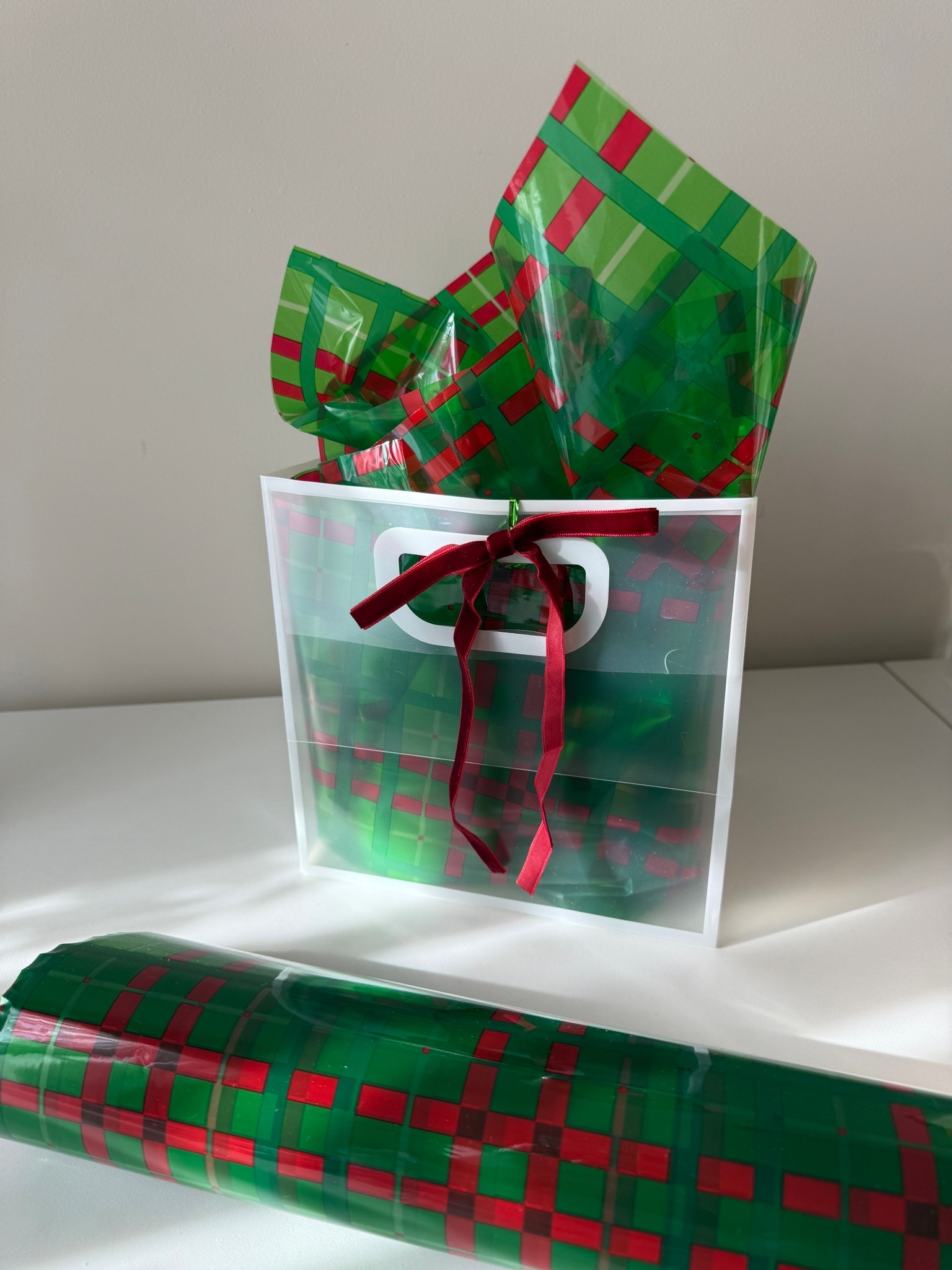 Easy and affordable way to elevate gift wrap!!
This red and green plaid Christmas cellophane wrap is a total holiday essential 🎄🎁 I used it inside a clear plastic gift bag for extra color and texture, but it’s perfect for wine bottles, odd-shaped gifts, gift baskets, cookie gifts, and even in place of tissue paper in gift bags like I’m doing!! Such a fun swap that instantly makes any gift look more elevated.

It’s super durable too. 3 mil thick, doesn’t rip, and the roll is huge. You get 100 ft of cellophane and once unfolded it’s a full 34 inches wide. So good for stocking up and using all season long.

Bright plaid pattern, sturdy, festive, and makes your gifts look professionally wrapped without the effort ❤️💚

🔍 Christmas cellophane wrap, plaid gift wrap, red green cellophane, holiday gift wrap, Christmas basket wrap, wine bottle wrap, gift bag filler, Christmas packaging ideas, DIY gift baskets, holiday hampers, sturdy cellophane, non-rip wrap, Christmas gifting, holiday storage ideas, Christmas wrapping supplies, LTK holiday finds, festive wrapping paper, gift wrap ideas 🎄✨

#LTKCyberWeek #LTKHoliday #LTKFindsUnder50