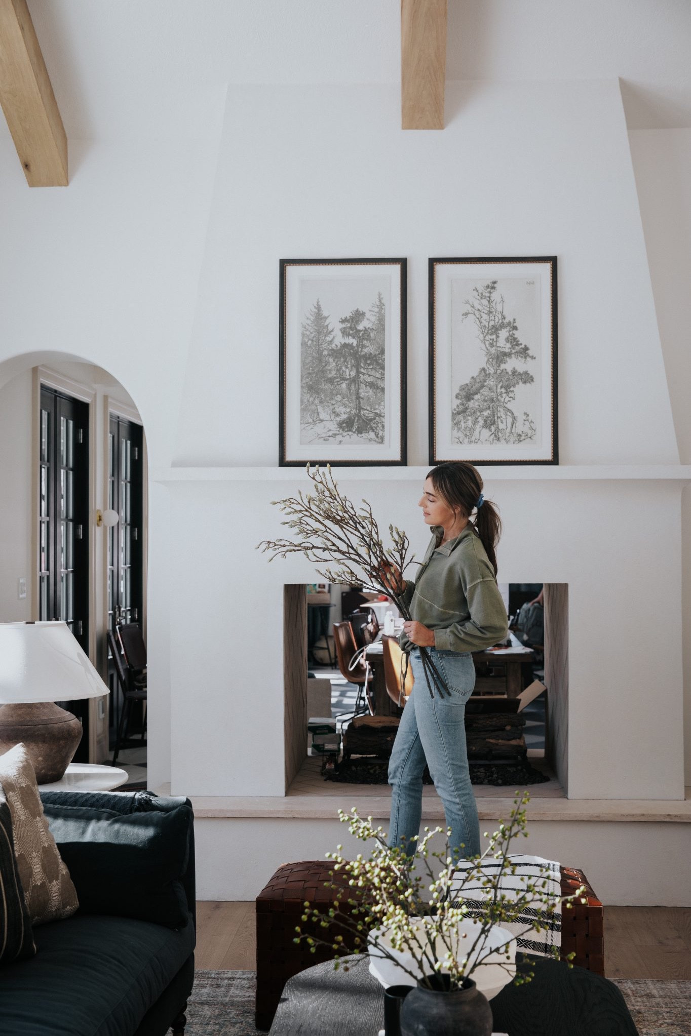 Aesthetically, it's a romantic notion to swap out your stems for whatever's in season. Keep a tote of your favorites and restock your vases as the seasons change. 

Living room, fireplace, tree art, faux stems, coffee table, rug, woven ottomans, velvet couch, table lamp, coffee table books

#LTKhome #LTKstyletip