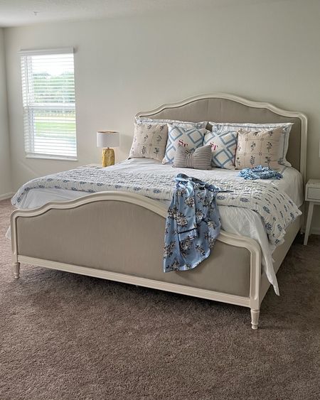 Classic French country bed frame with blue bedding accents  

#LTKhome #LTKeurope