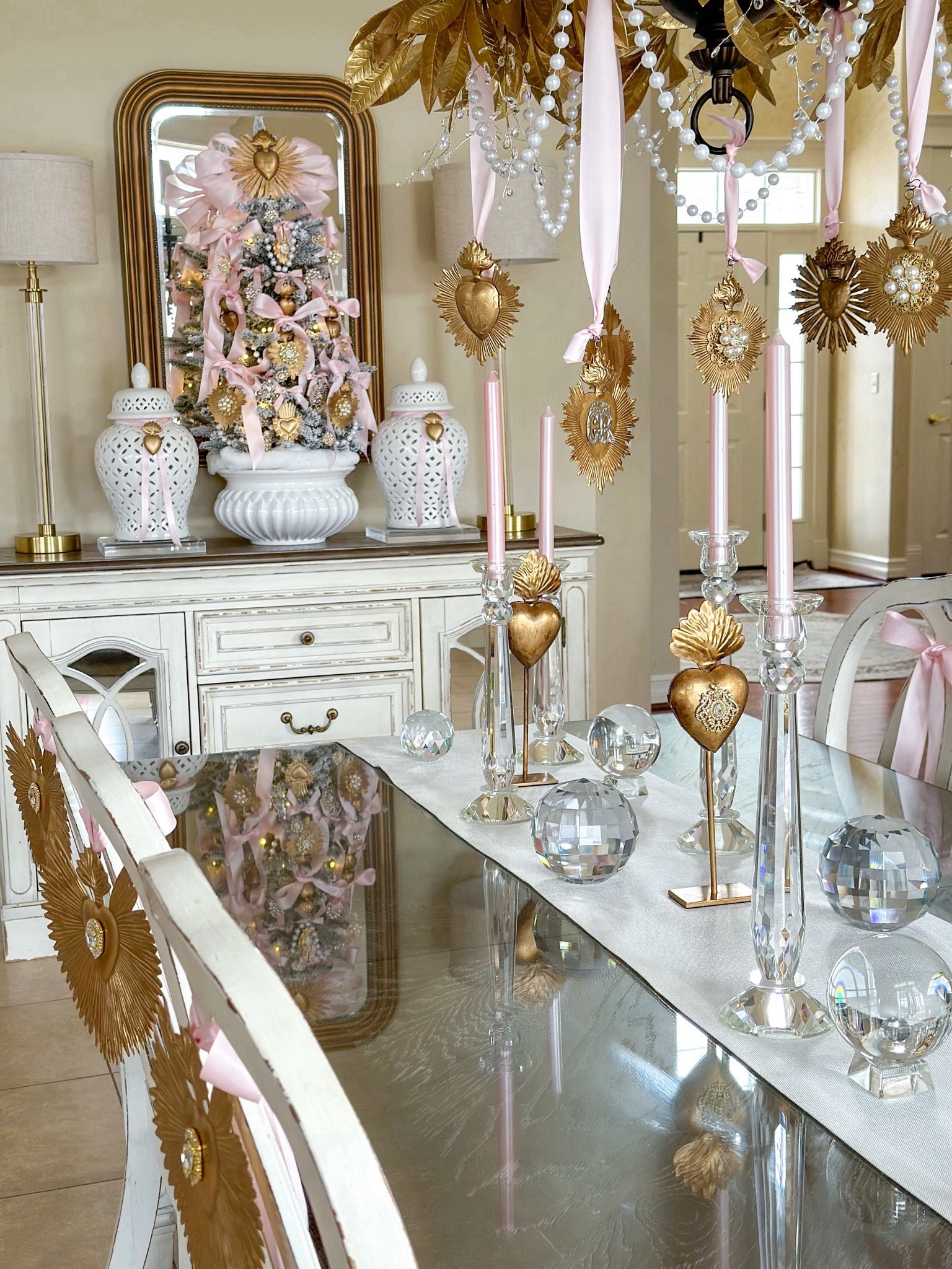 Shop my Valentines Day tree and centerpiece!

Valentine’s Day tablescape, valentines decor, tablescape inspo, valentines centerpiece, sacred hearts, Milagro hearts, valentines table, crystal candleholders, pink candles, pink ribbon, gold hearts, crystal orbs, buffet lamps, acrylic risers, pearl garland, white table runner, valentines inspiration

#LTKfindsunder50 #LTKSeasonal #LTKhome