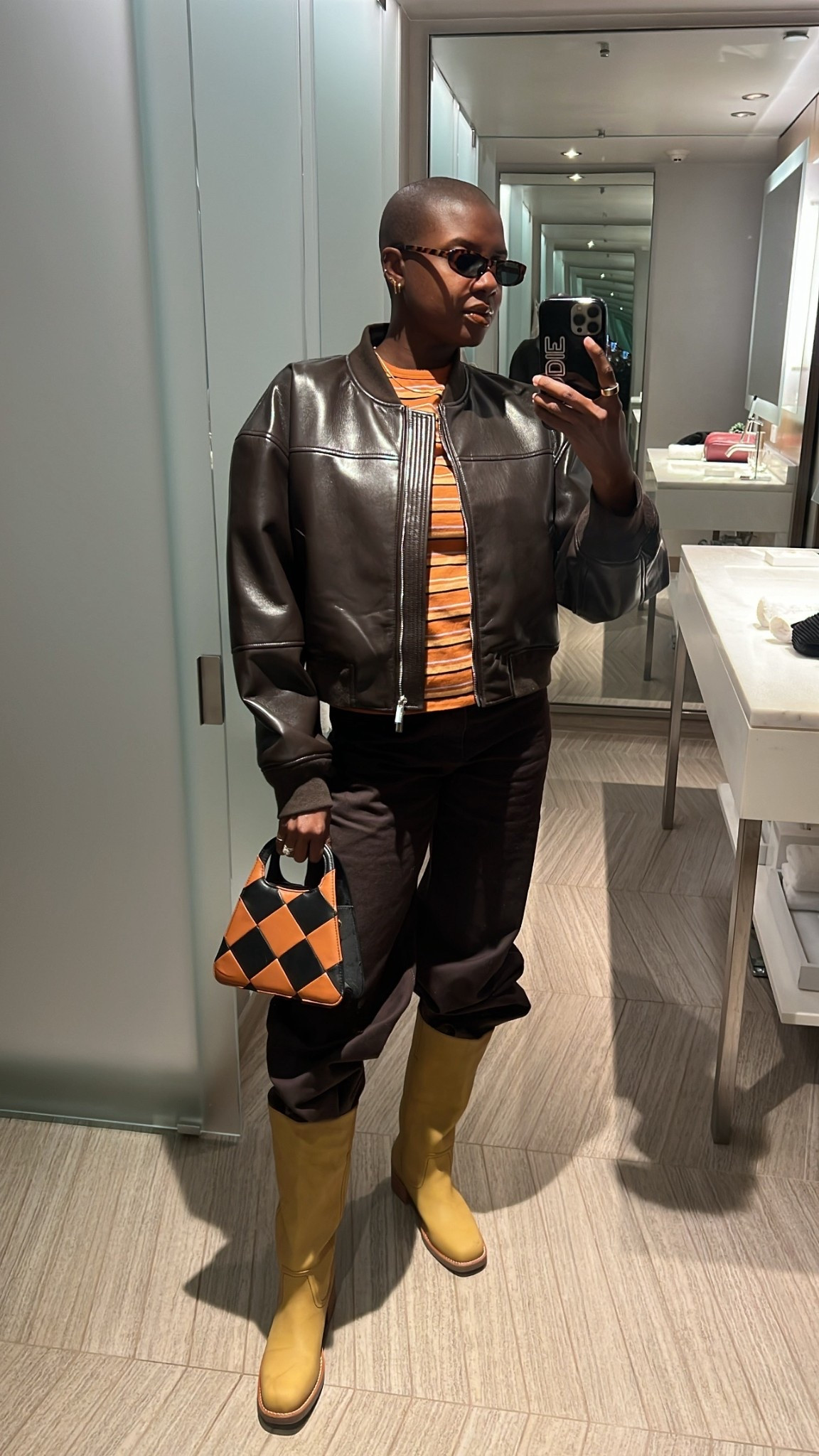 Casual winter outfit for New York! Brown leather bomber jacket, brown wide leg denim jeans, 70’s striped tee , rectangular tortoise sunglasses and alohas checkered hand bag  

#LTKootd #LTKdayinmylife #LTKgrwm