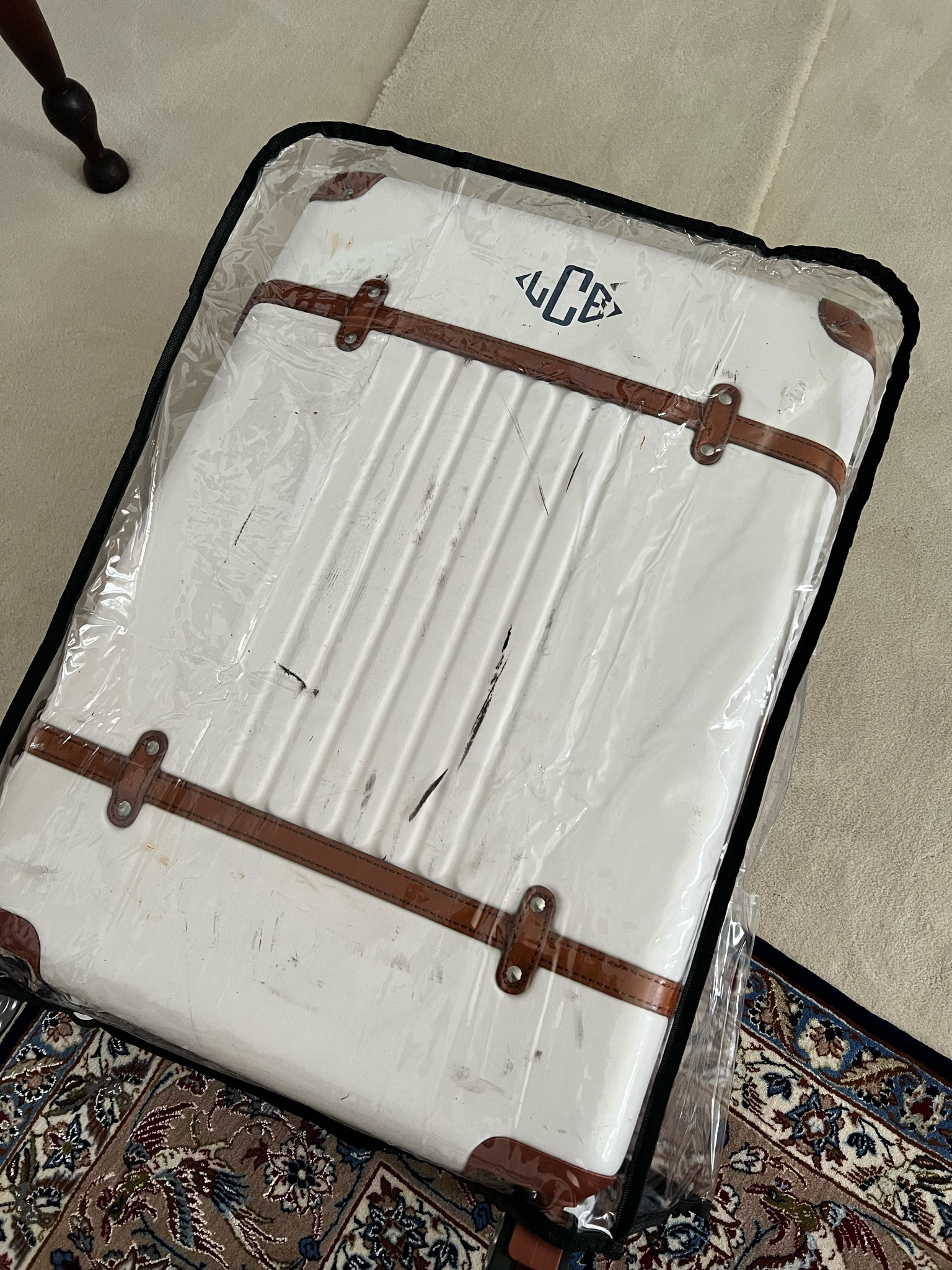 Worried about white luggage getting abused by the airlines? Save it with this plastic luggage cover! 