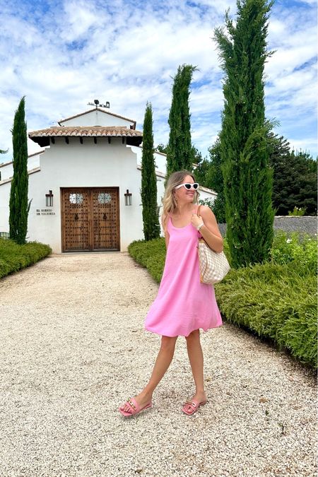 Pink Summer Dress. Fashion Blogger Girl by Style Blog Heartfelt Hunt. Girl with blond hair wearing a pink summer dress, white cat-eye sunglasses, Louis Vuitton bag and pink sandals. #pinkdress #summerdress #colorfuloutfit #colorfulstyle #colorfulfashion #colorfullooks #fashionfun #cutesummeroutfit #summerfashion2023 #summerlookbook #fitcheck #dailylooks #dailylookbook #contentcreator #microinfluencer #discoverunder20k