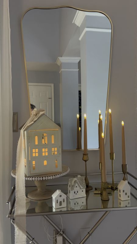 Love these flameless taper candles in beige from Amazon next to the metal tin house with a diffuser going for an extra cozy vibe! 

Tin house from Michael’s last year but similar houses linked on Amazon. 

Metal curved Arched mirror, gold metal mirror, curved mirror, gold wall mirror, color changing essential oil diffuser, gold candle holders, antique brass taper candle holders. 