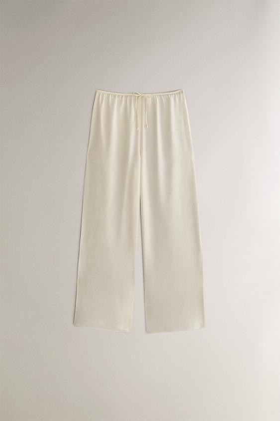 SILK TROUSERS119.99 GBPEcru | 8180/122/712Put it in your basketAddPlain-coloured silk trousers wi... | Zara UK