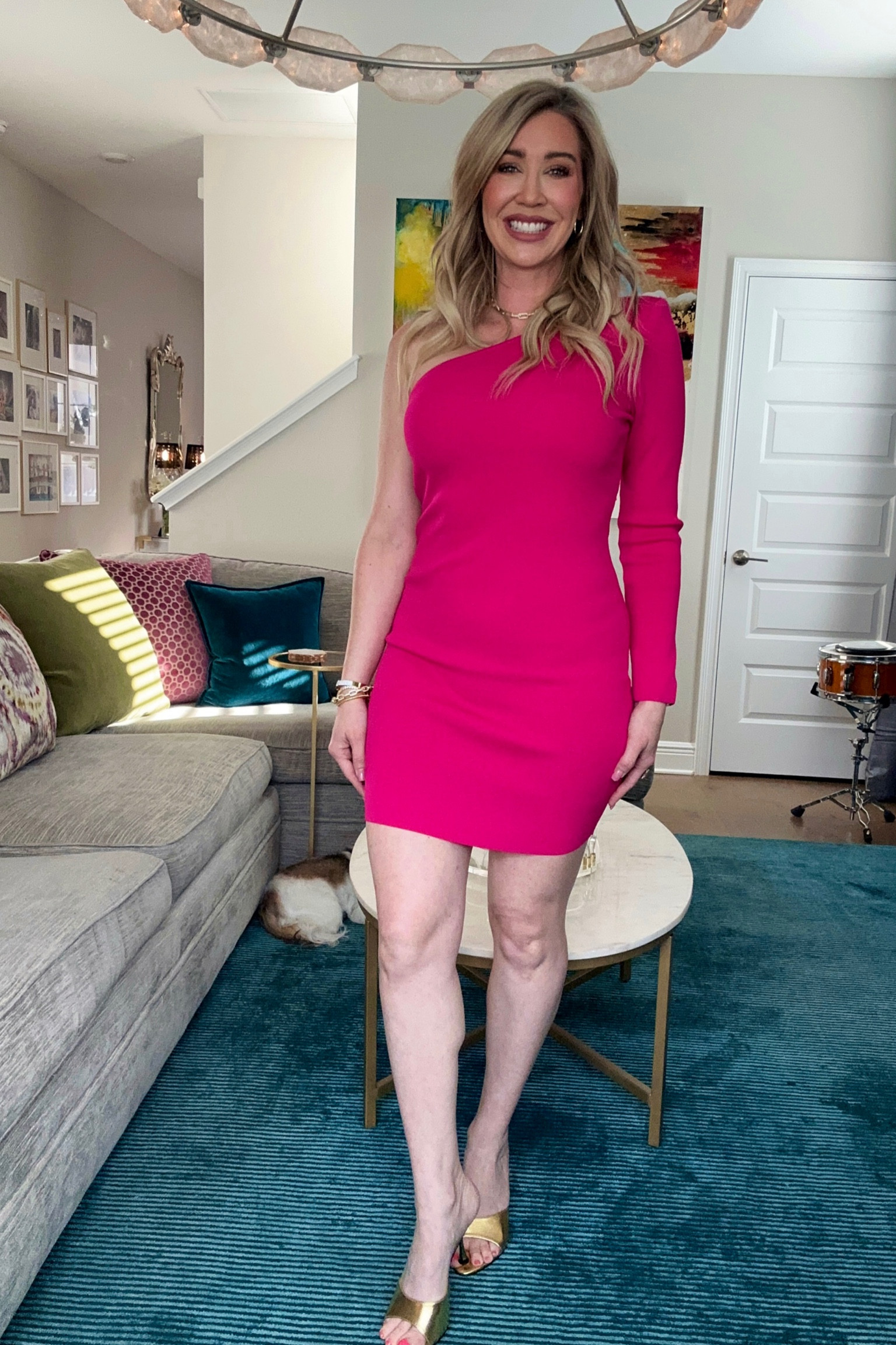 This dress is so fun! Love the one sleeve. It has padding in the should to give nice structure and shape. Fabric is very flattering and not clingy. 
Wearing a medium 