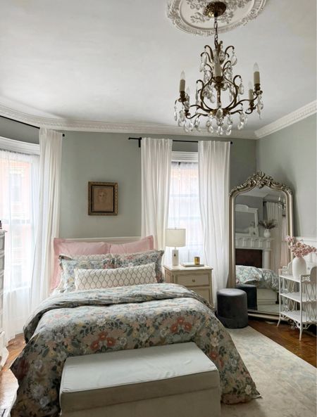 Bedroom sources – floral bedding, duvet, sheets, pink coverage, quilts, pillowcases, sham, rug, floor, mirror, fringe, velvet, ottoman, crystal chandelier, linen curtains, sheer curtains