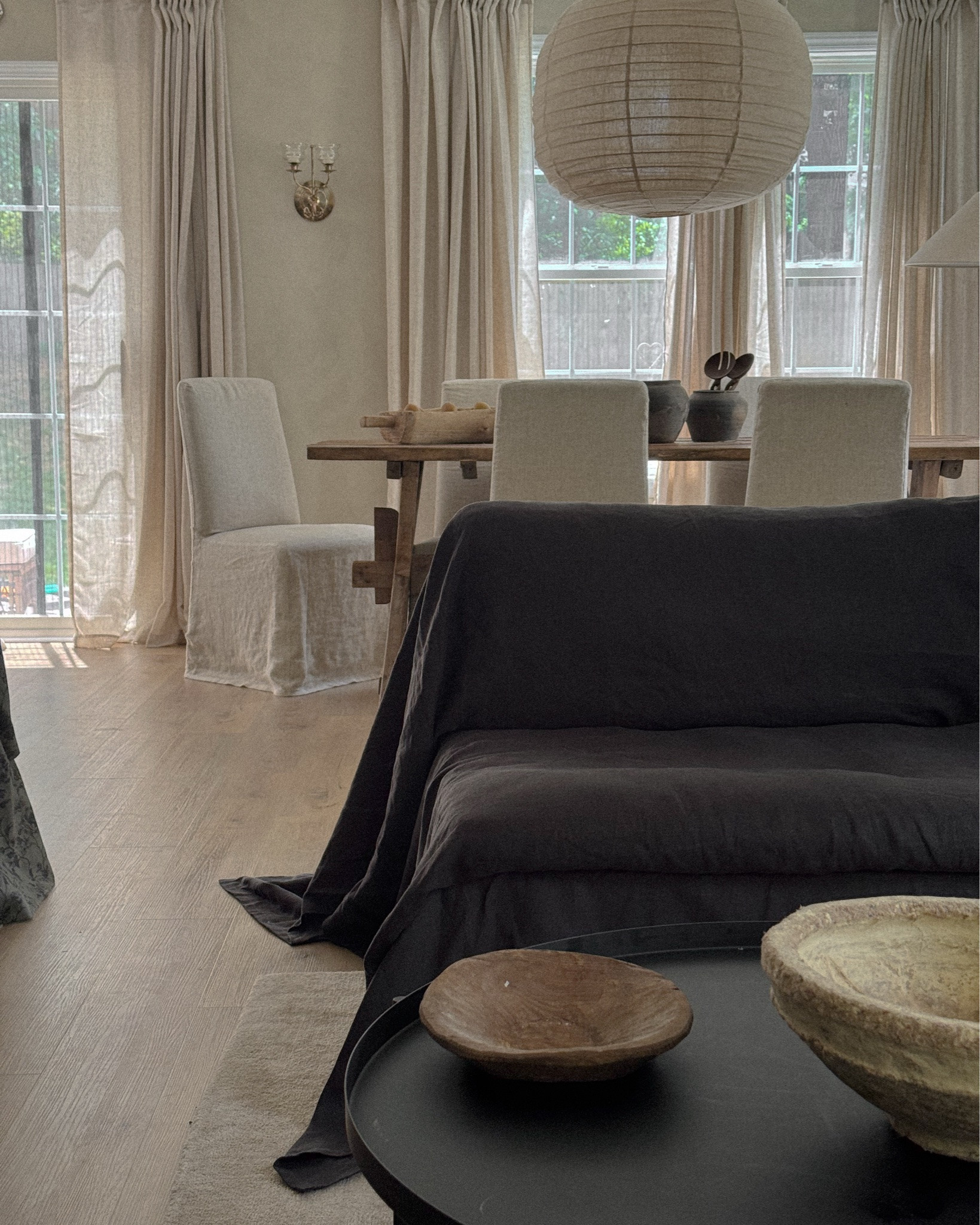 A little corner of calm 🤍
Layered linen, soft neutrals, moody contrast, and pieces that feel collected over time. Linking the slipcovered seating, paper lantern, curtains, lighting, rugs, tables, and decor details that make this space feel warm and lived in.

My favorite kind of room is one that feels quiet, imperfect, and cozy, like an old world home with a modern softness. Everything linked here for those asking 🫶🏽 #livingroom #cozyinteriors

#LTKHome #LTKselfcare