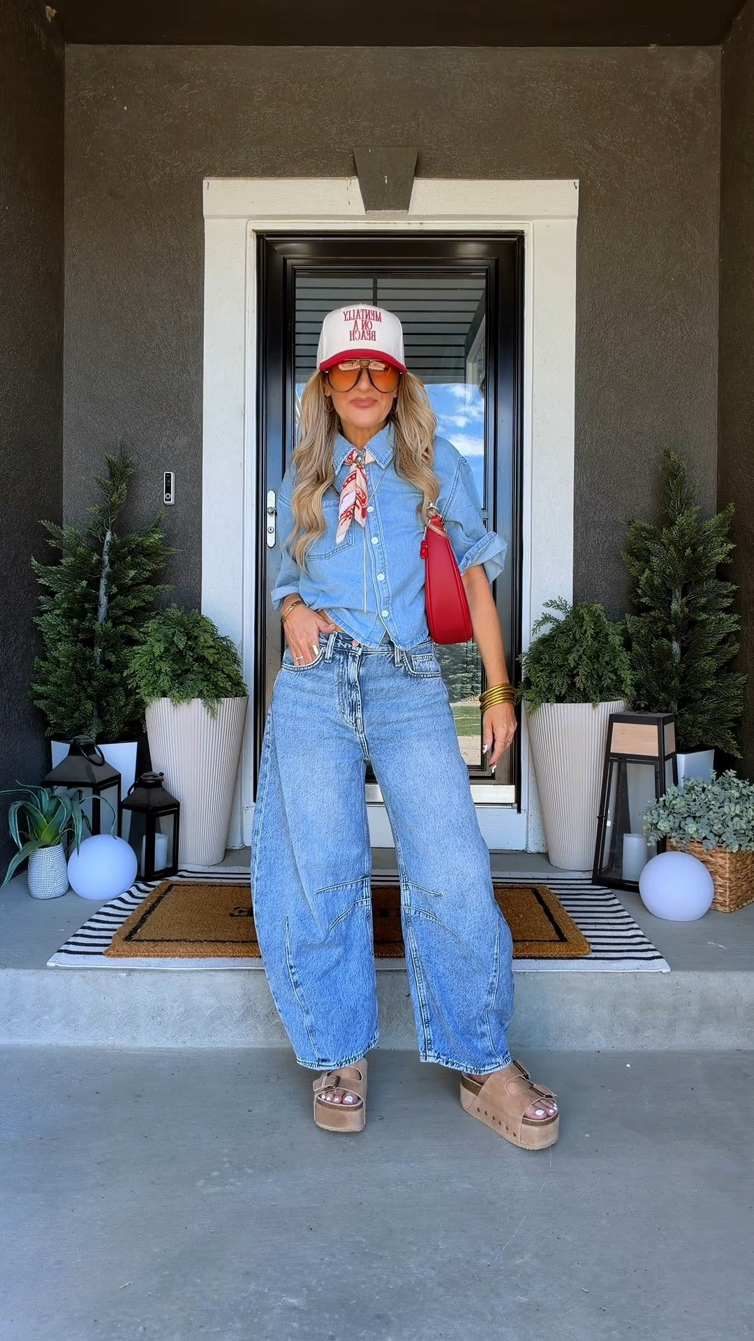Modern western outfit featuring horseshoe jeans, a cropped denim button-down, platform sandals, and a trucker hat. I love western fashion pieces that feel current and easy to wear instead of looking overly themed. The red bag adds the perfect pop of color to this casual denim-on-denim look.

#LTKStyleTip #LTKSeasonal #LTKVideo