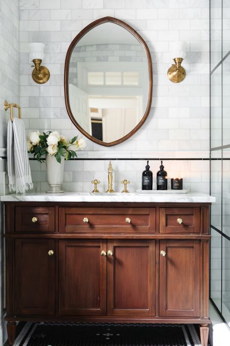 Greta’s Bathroom 🖤

Wooden vanity, shield shape mirror, column vase, brass faucet, towel ring, sconces, brass knobs, faux peony stems

#LTKhome #LTKSeasonal