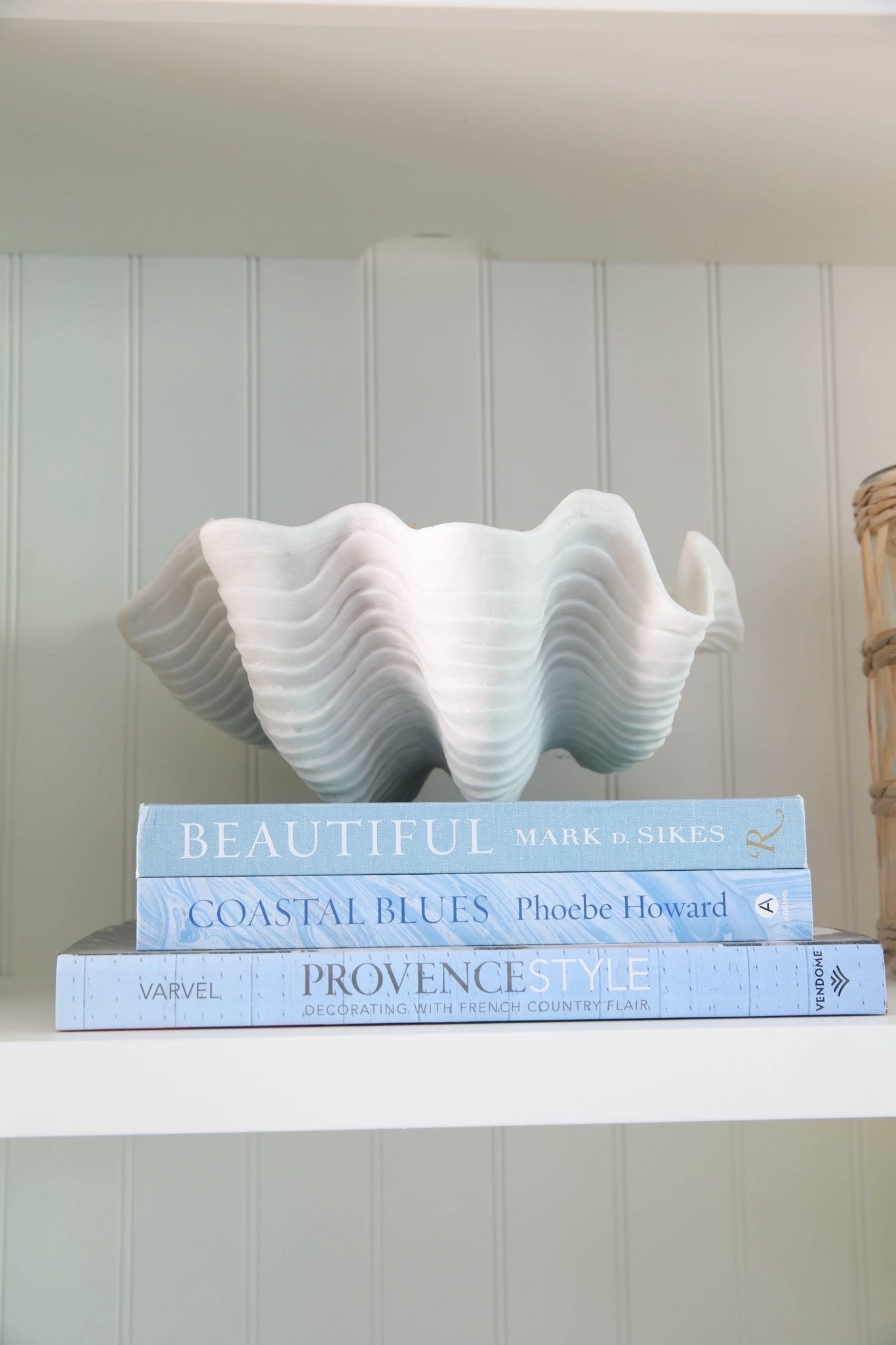 My shelf decor features coastal coffee table books and a decorative shell bowl for a clean, layered, designer-inspired coastal look. I love how blue and white accents mixed with natural textures make these shelves feel styled but not cluttered. 

#LTKU #LTKHome #LTKSaleAlert