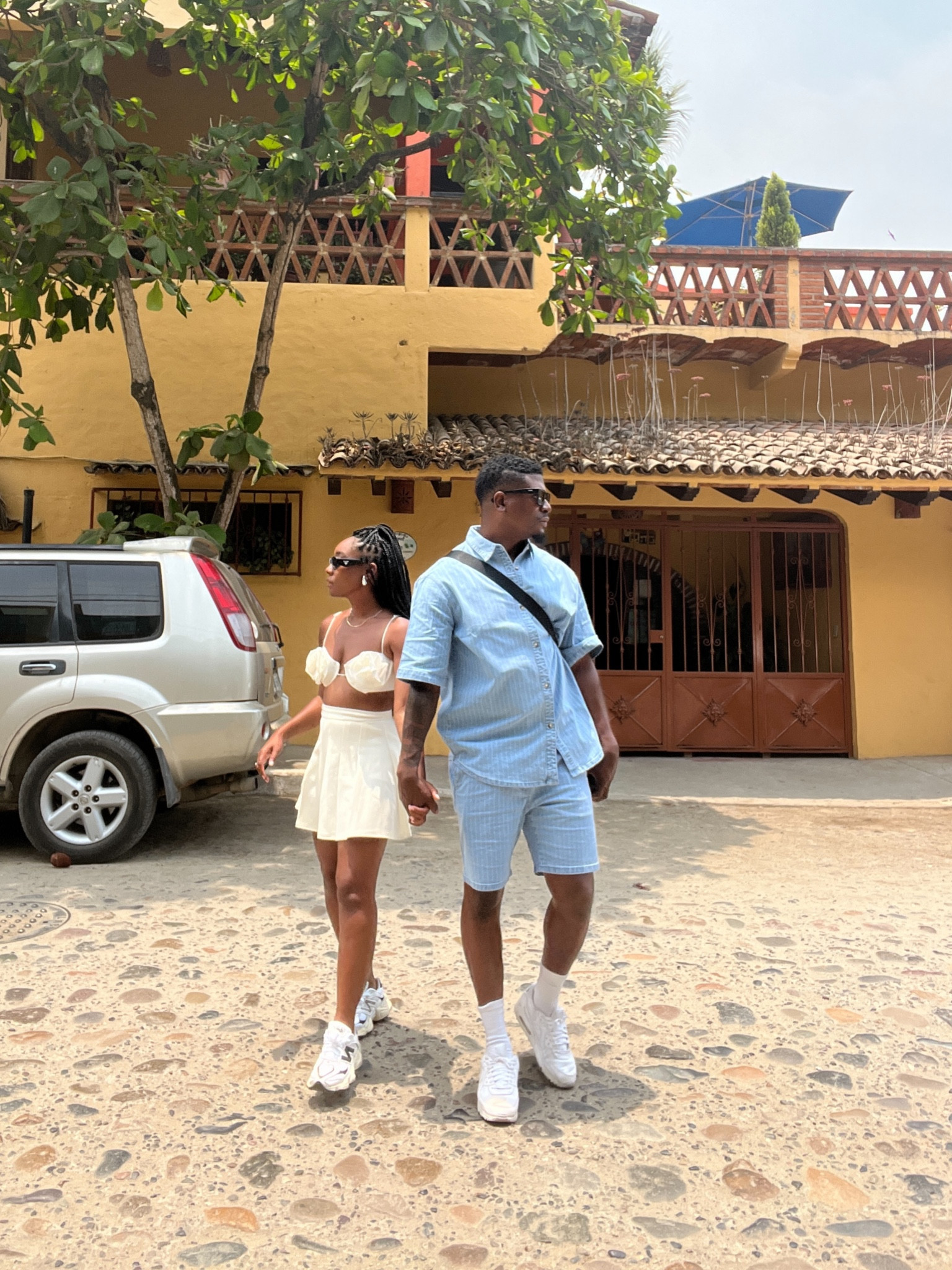 Couples vacation outfits. Flower bra, tennis skirt, new balance dad sneakers, men's denim shorts and button down top set. 

#LTKshoecrush #LTKfamily #LTKmens
