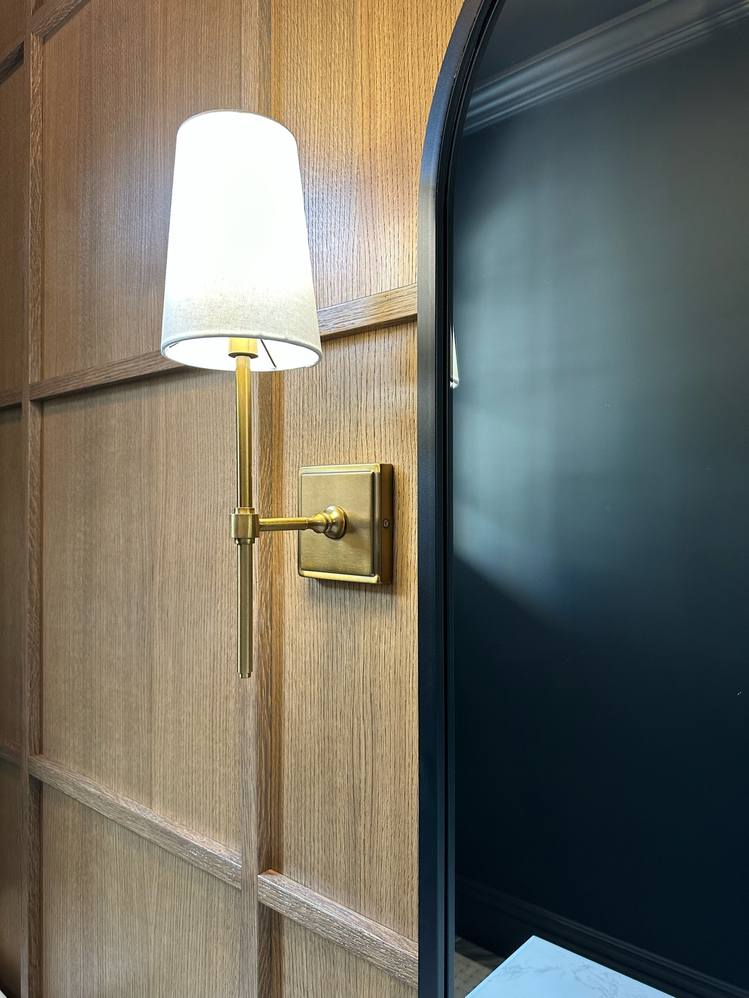 Home decor • brass wall sconce • wall mounted light • brass fixtures • bathroom fixtures • bathroom decor • black arched mirror • wall mirror • framed mirror • 

#LTKhome #LTKsalealert