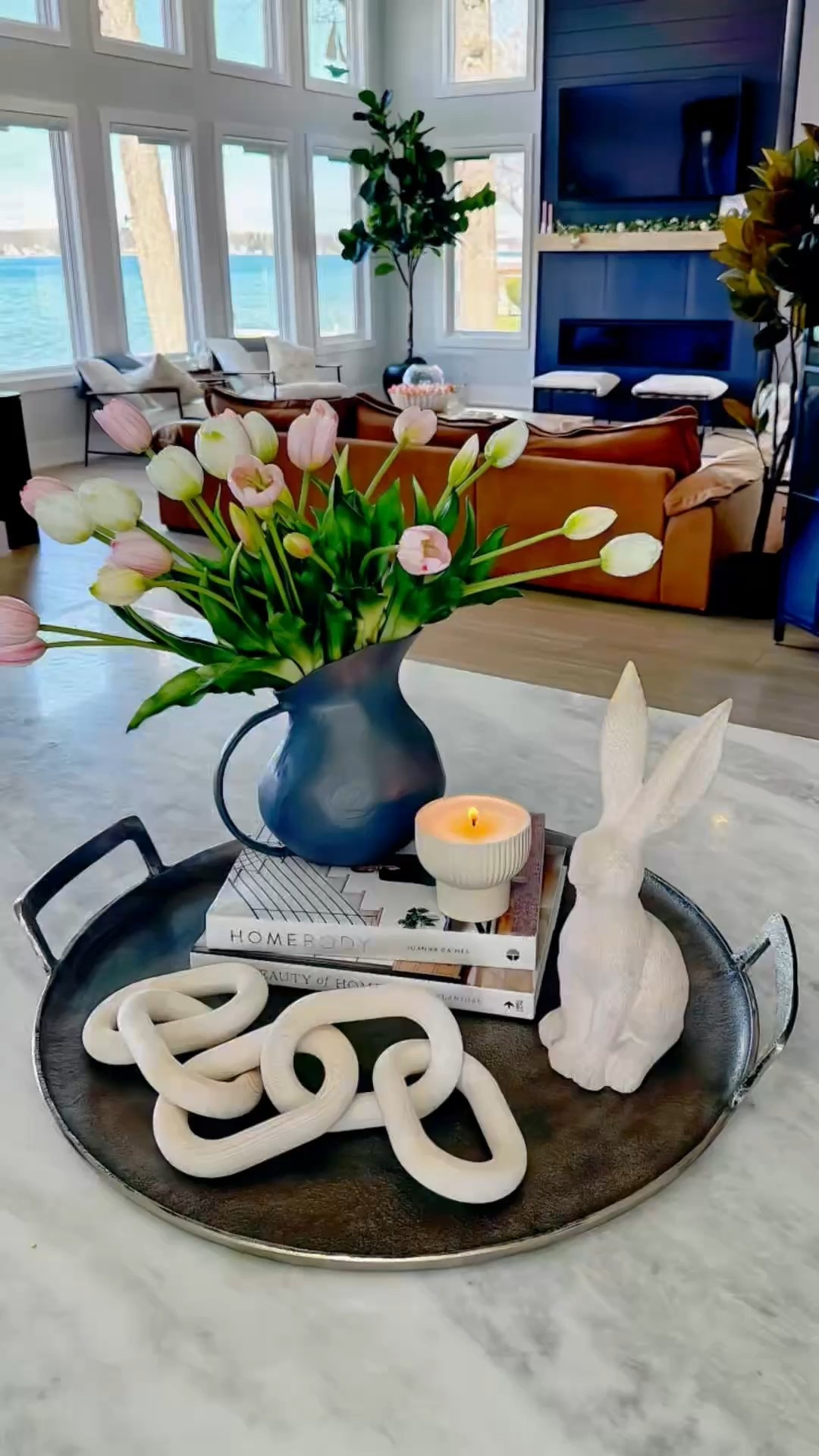A Simple Yet Bold Large Spring Centerpiece 🐰🌷 

A simple aluminum tray became the perfect base for my spring and Easter centerpiece! I added two books to create height for my charcoal picture vase, which I filled with beautiful real-to-touch white and pink tulips. A sweet bunny, a cute candle, and a light wood chain completed the look—effortless yet so pretty! This easy setup brings a fresh and festive touch to the season.

#SpringDecor #EasterDecor #HomeStyling #centerpiecesideas @cghunterhome #ad #cghunter

#LTKWatchNow #LTKSeasonal #LTKHome