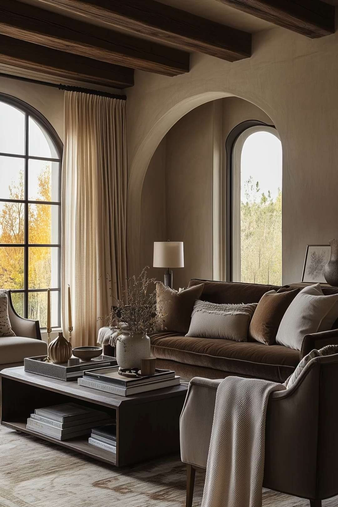 This luxurious living room exudes timeless elegance with its neutral tones and modern design. The space showcases a blend of cozy textiles, such as the plush sofas and layered cushions, alongside rustic wooden ceiling beams. Natural light filters through the large arched windows, highlighting the sophisticated decor and providing a warm, inviting atmosphere. The coffee table, adorned with stacked books and decorative vases, adds a touch of minimalistic charm. 🖤 If you want to see more content like this, FOLLOW maeveandmodern on LTK, Instagram, and Pinterest! Check out our blog where we post daily, maeveandmodern.com!

neutral living room | modern design | cozy textiles | rustic beams | arched windows | sophisticated decor | minimalist charm | elegant interiors | luxe style | welcoming atmosphere | home styling | interior inspiration | warm tones | chic decor | plush upholstery | decorative vases | natural light | timeless elegance | stylish spaces | interior trends
 

 

#LTKHome #LTKSaleAlert #LTKFindsUnder100 #LTKSeasonal #LTKHome #LTKSaleAlert