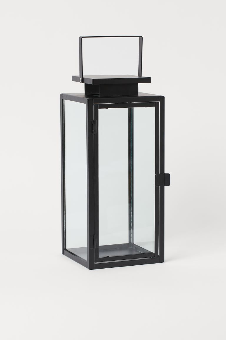 Large lantern in metal and clear glass designed to hold a pillar candle. Handle at top and opens ... | H&M (US + CA)