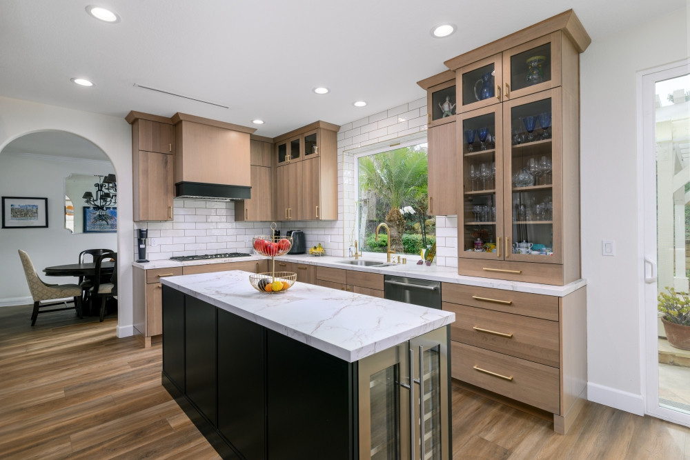 This kitchen is the definition of custom-crafted elegance. We supplied the cabinetry for this full remodel, blending warm white oak with a bold black island to ground the space in contrast and style. From the glass-front cabinets to the oversized drawers and wine cooler, every inch is thoughtfully designed to blend beauty with function. The quartz countertops and classic subway tile backsplash tie the whole look together for a space that feels fresh, timeless, and uniquely tailored.

Looking to elevate your kitchen? Let us bring your vision to life—cabinet by cabinet.

#CustomKitchenDesign #KitchenRemodel #WhiteOakCabinets #BlackKitchenIsland #GlassCabinetDoors #LTKHome #PinterestKitchen #DesignBuildFirm #CabinetryInspo #QuartzCountertops #ModernClassicKitchen #TimelessDesign #WineCoolerCabinet #KitchenStorageGoals #InteriorDesignInspo 

 #LTKHome