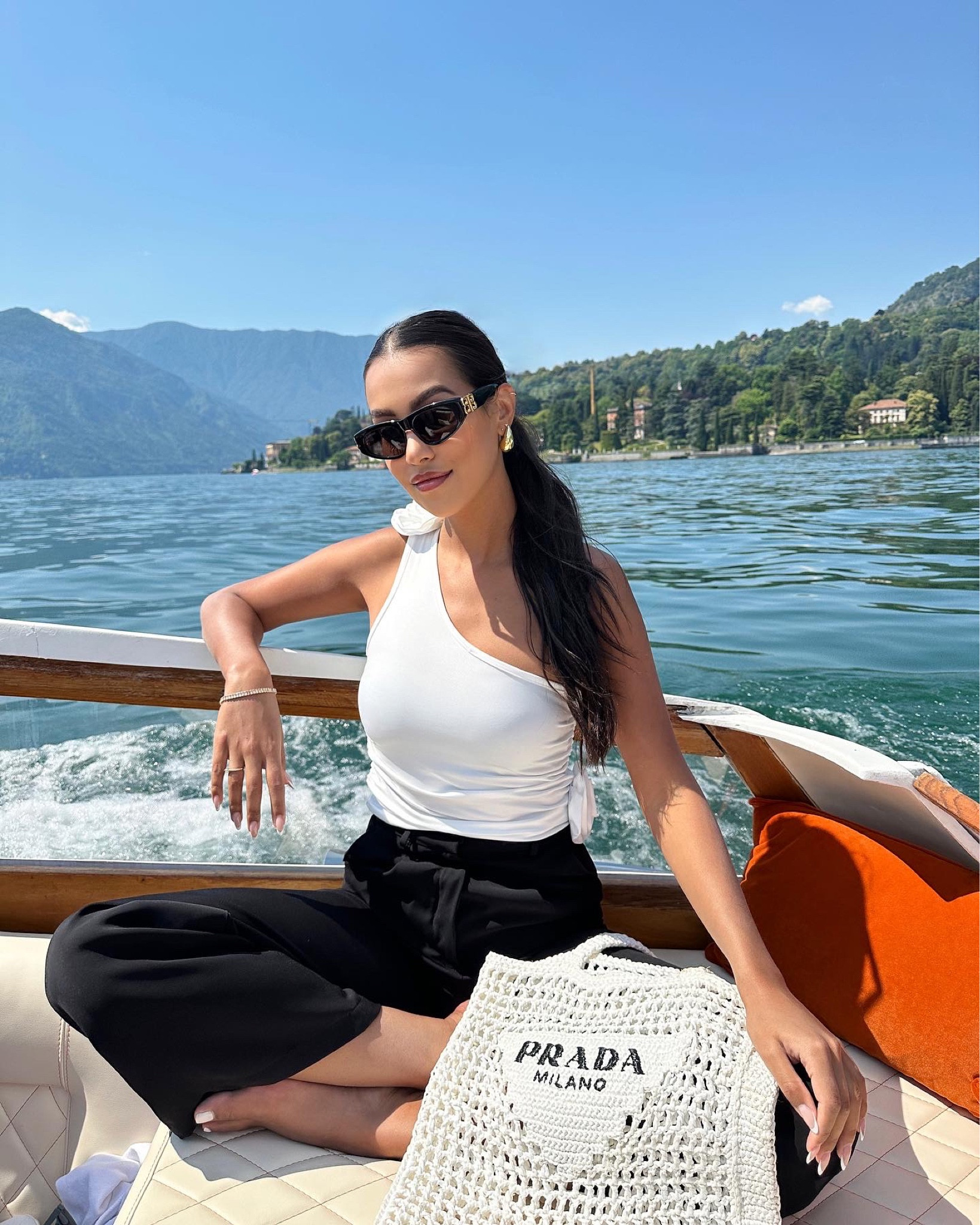 I love a rosette-accented top paired with a sleek trouser. Inspired by one of Sofia Richie’s honeymoon looks. Prada bag, prada, black trousers, Balenciaga sunglasses, prada crochet tote 

#LTKstyletip #LTKSeasonal #LTKtravel