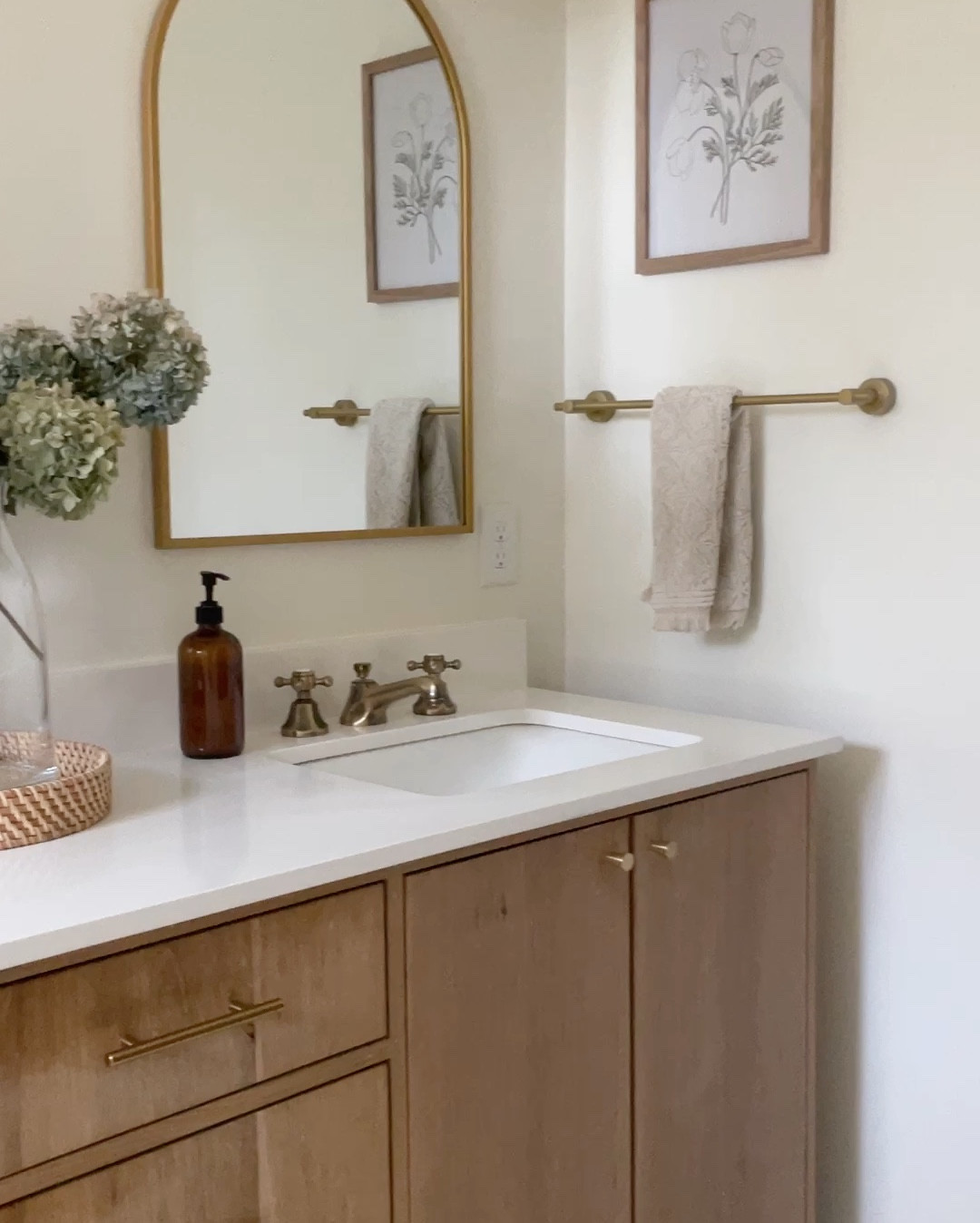 Master bathroom details from our artisan shower tile to the custom white oak double vanity.  

Wooden double vanity.  Kingston brass antique brass faucets.  Kohler sink.  Brass arched mirror Target.  Brass hardware.  Hexagon ceramic porcelain mosaic floor tile.  12 X 14 Carrara marble like floor tile.  Kohler toilet.  

#LTKhome #LTKxTarget #LTKfamily
