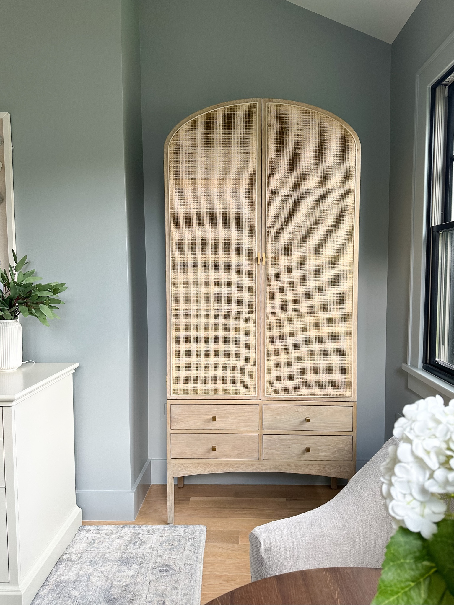 Save 25% off my arched rattan an oak cabinet. This is an armoire but I use it in my office as closed storage. This is a very high-quality piece. The four drawers on the bottom have a soft close function. 

#LTKhome #LTKCyberWeek #LTKsalealert