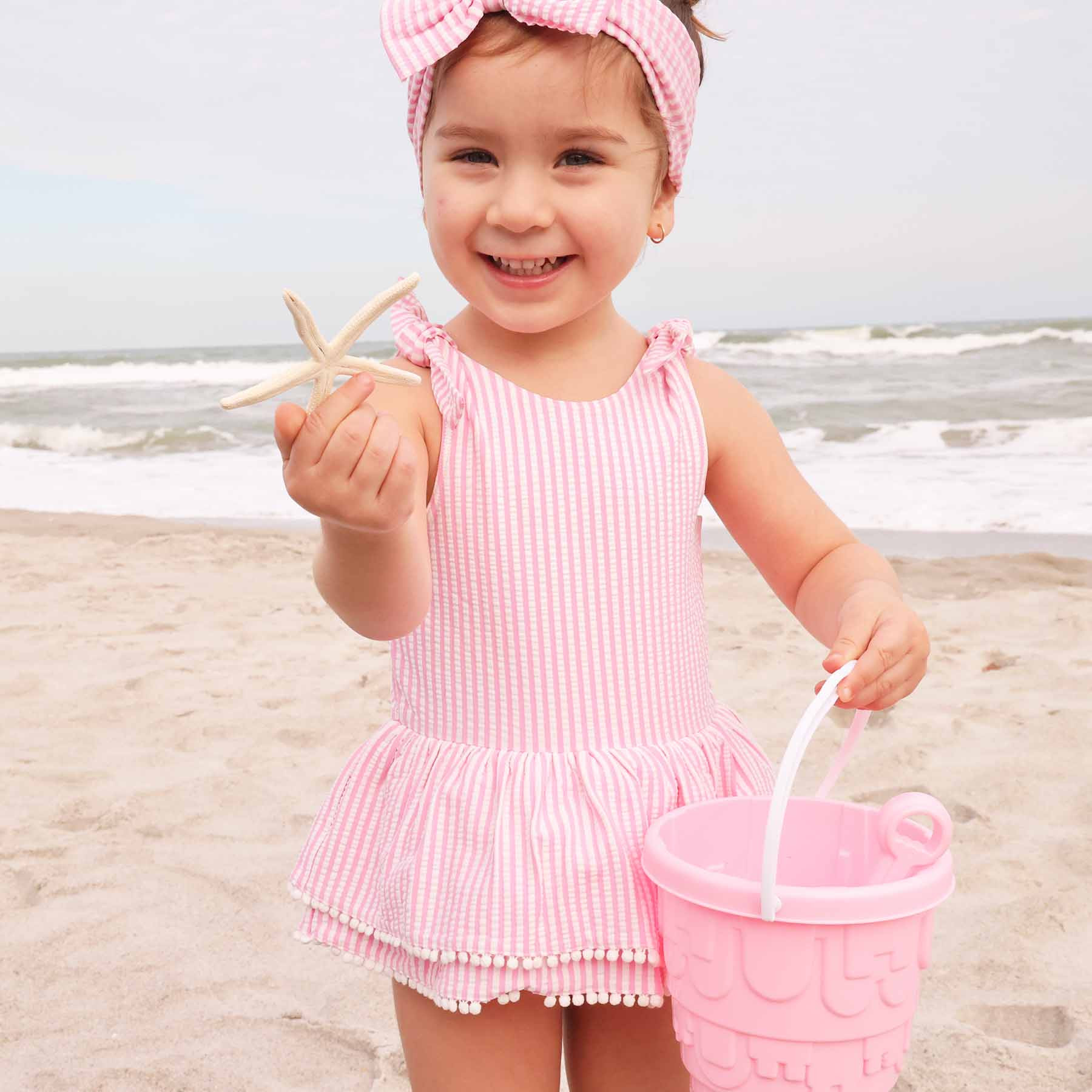 Tiered Skirt with White Pom Trim | Seersucker Dusty Pink | Caden Lane