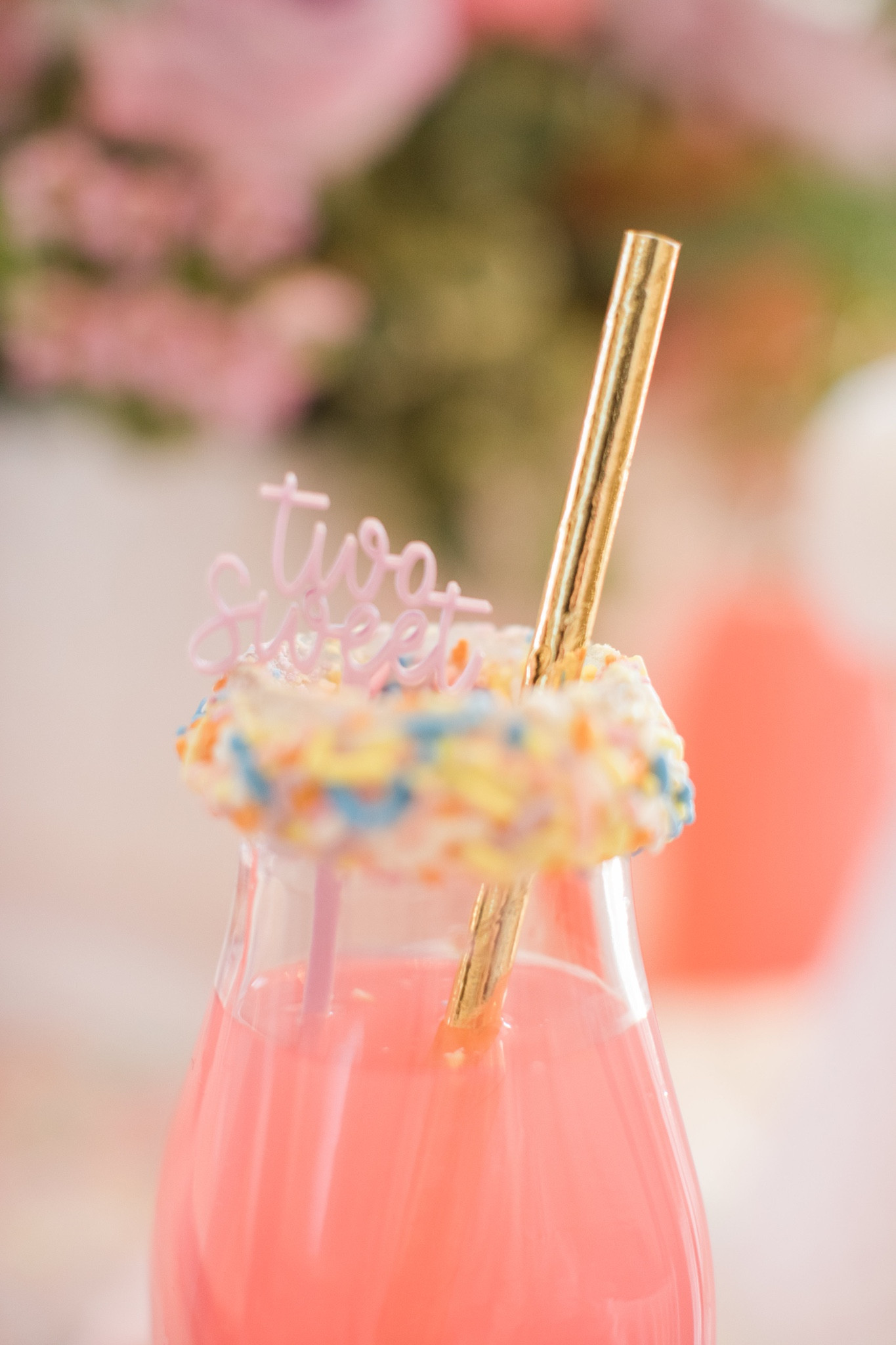 Two sweet! Who said drinks have to be boring? We used a glass milk bottle, tossed the caps and added icing around the rim and covered with the cutest sprinkles! The #merimeri straws and TWO SWEET drink stirrer add the cutest touch! 

#twosweet #birthday #birthdayparty #hearts #candyhearts #tablescape #placesetting #confetti #sprinkles #floral  #drink #drinkstirrer #straw #pinklemonade