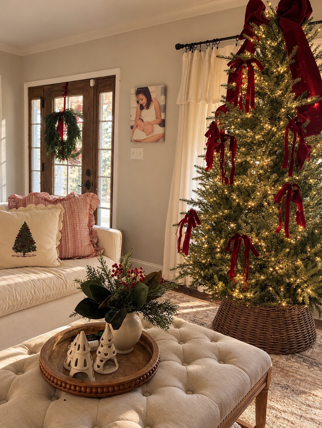 Cozy Christmas decorating with a touch of traditional charm! 🎄❤️ Loving the rich burgundy velvet bows, warm twinkle lights, natural cedar greenery, and woven tree collar. The mix of classic Christmas reds, soft neutrals, and rustic textures makes this living room feel so warm and inviting! Sharing my favorite Christmas tree decorations, holiday pillows, and cozy home decor finds. Shop the look on LTK! ✨
