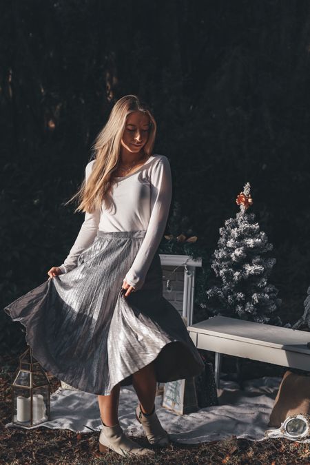 Winter holiday outfit with a silver metallic skirt

#LTKSeasonal #LTKunder50