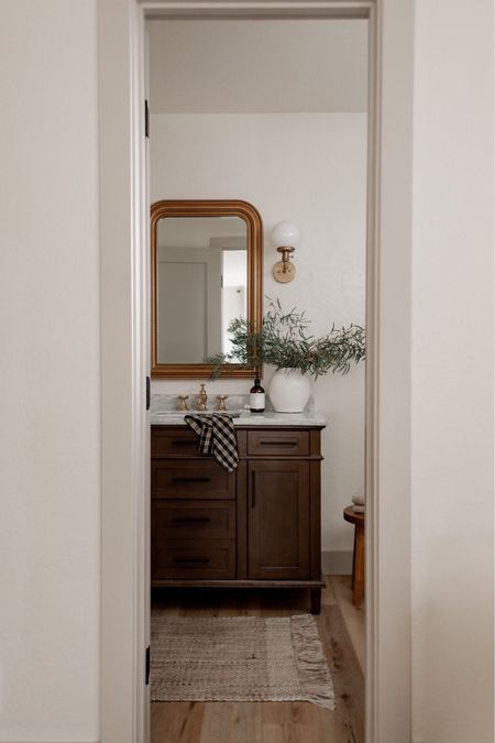 Create a designer look for less in your bathroom with this gorgeous wood vanity, gold mirror, and bathroom decor! 

#LTKhome #LTKSeasonal #LTKsalealert