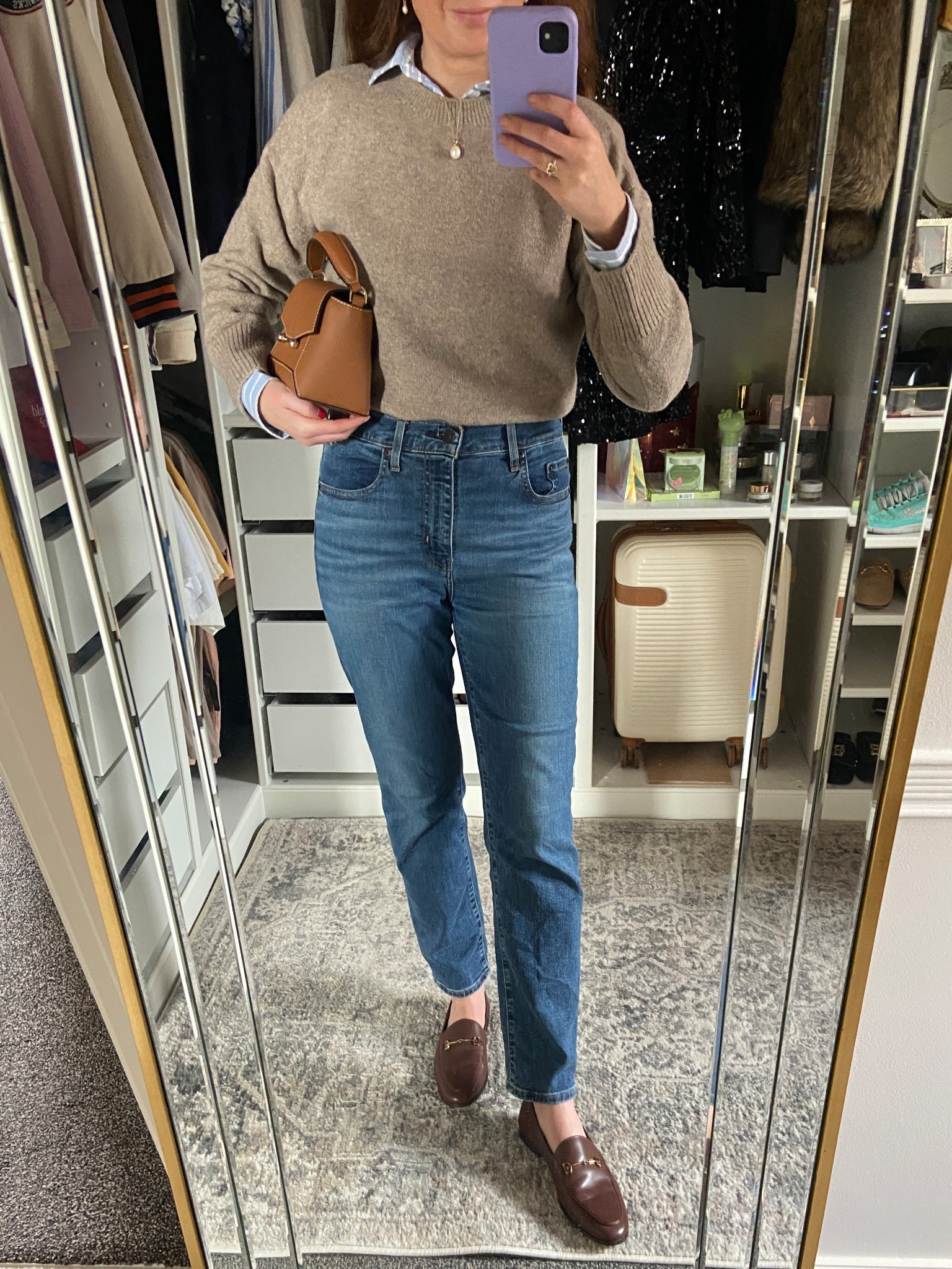 Weekend ready autumn outfit 🍂 cosy, classic, and effortless! I layered a neutral beige crewneck sweater over a crisp blue striped shirt for that timeless preppy vibe, paired with high waisted straight leg jeans that are comfy yet flattering. These rich brown leather loafers add a touch of polish while staying practical for running Saturday errands, grabbing coffee, or picking up fresh blooms at the flower market 🤎🍂☕️. Finished the look with a structured tan crossbody bag and my everyday pearl necklace for a minimalist touch.  

#LTKuk #LTKluxury #LTKautumn