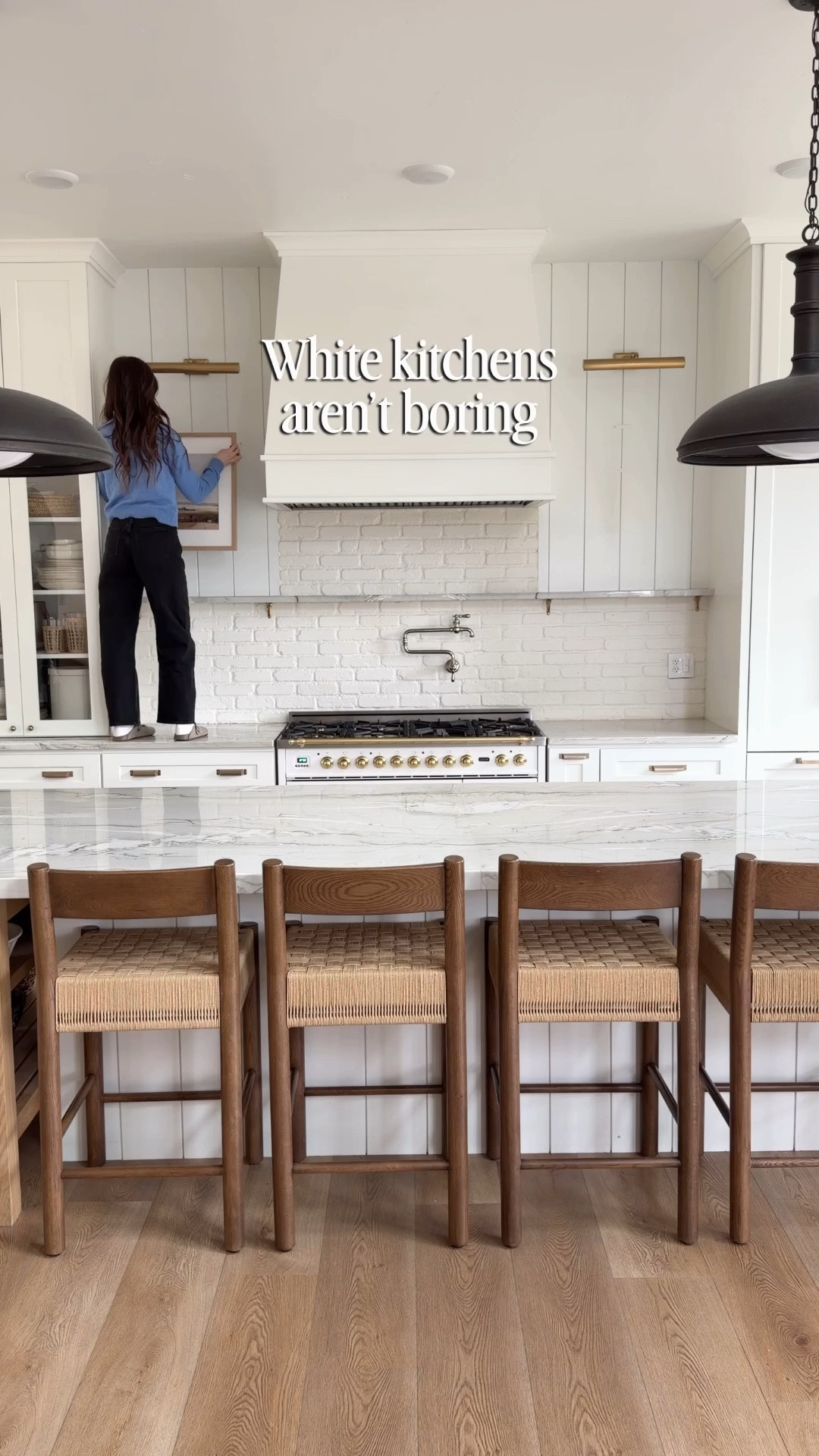 White kitchens don’t have to feel sterile 🤍 layering warm textures, wood tones, greenery, and art makes all the difference.

Sharing sources for my kitchen styling including the island decor, cutting boards, pottery, branches, and kitchen accessories.

Everything linked here if you want to recreate the look.

white kitchen, kitchen styling, neutral kitchen, kitchen decor, kitchen island styling, cutting boards decor, wood kitchen accents, marble kitchen, picture lights kitchen, kitchen artwork, cozy kitchen decor, neutral home decor, layered home styling, kitchen accessories, modern traditional kitchen 

#LTKHome #LTKSaleAlert #LTKSeasonal