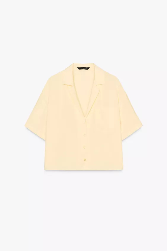 Flowing shirt. Features a lapel collar and v-neck, short sleeves, a chest patch pocket and a butt... | Zara UK