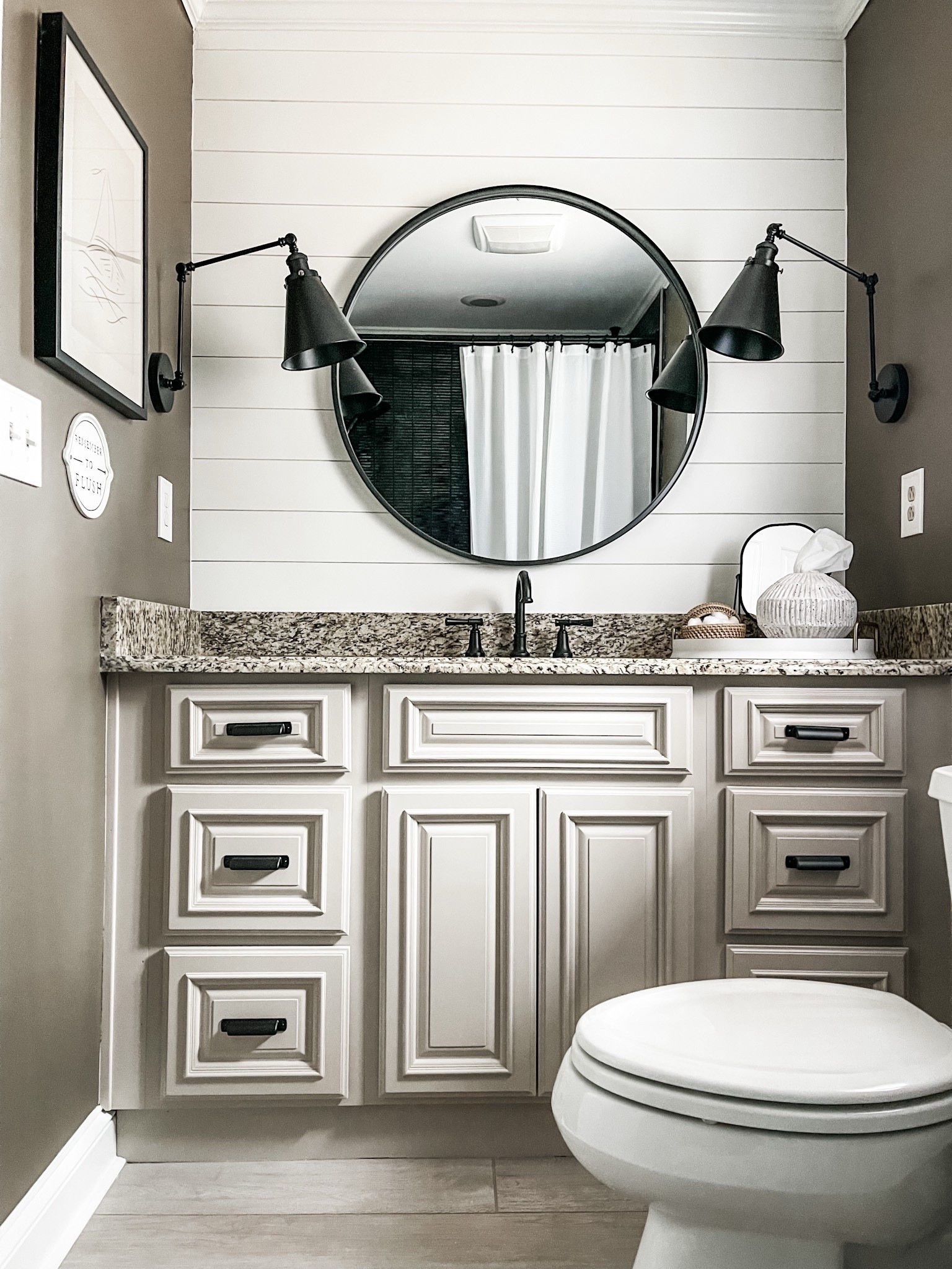 Effortless elegance in every detail 🤍 From the neutral vanity and granite countertop to the matte black fixtures and double swing-arm wall sconces—this powder room is proof that small spaces can still shine. Styled with a round black mirror, faux florals, and a simple tray of bathroom must-haves, it’s the perfect mix of timeless + functional.

#eanesinteriors #bathroomdesign #neutralbathroom #matteblackfixtures #granitecountertop #blackroundmirror #powderroomstyle #shakercabinetry #bathroomdetails #smallspaceinspo #shiplapwall #bathroomstyling #ltkhome #interiorinspo


#LTKFindsUnder100 #LTKvlog #LTKHome