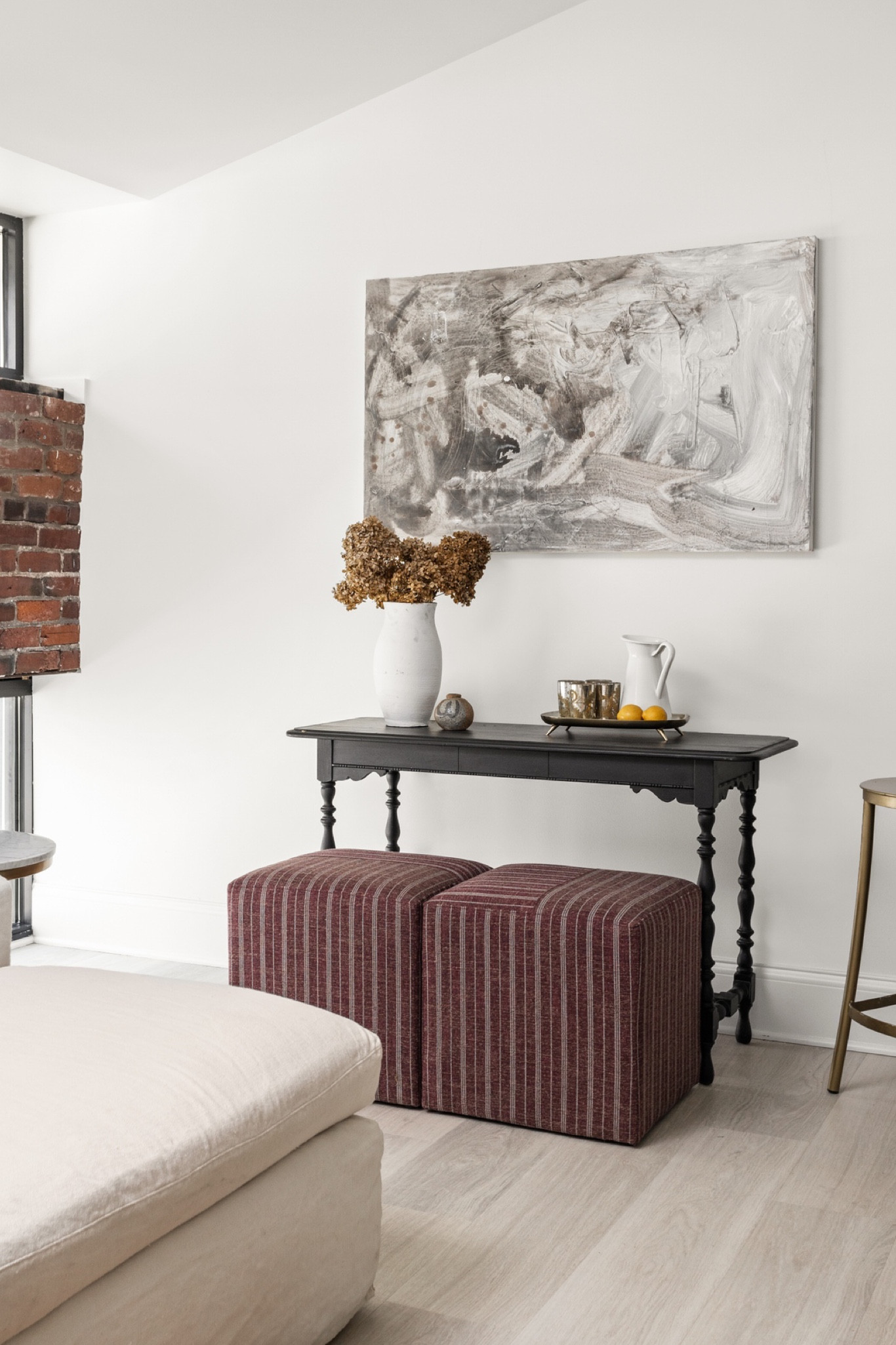 Fill a blank wall with a small table and decor, and add cubes for movable extra seating.

#LTKhome