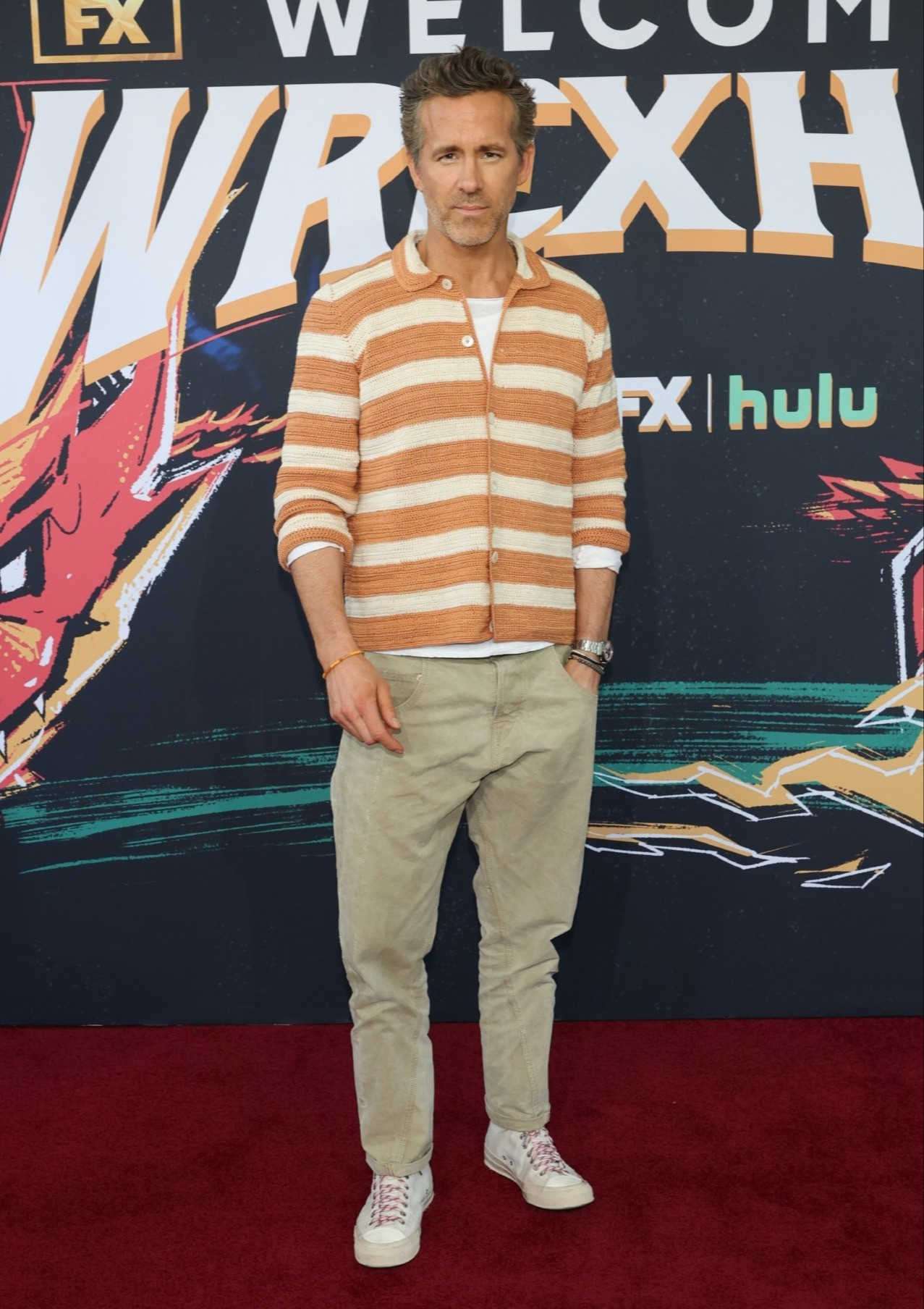 Ryan Reynolds wearing a crochet Bode shirt, Archie & Dennis army pants, Visvim sneakers, and Luis Morias bracelets 

 