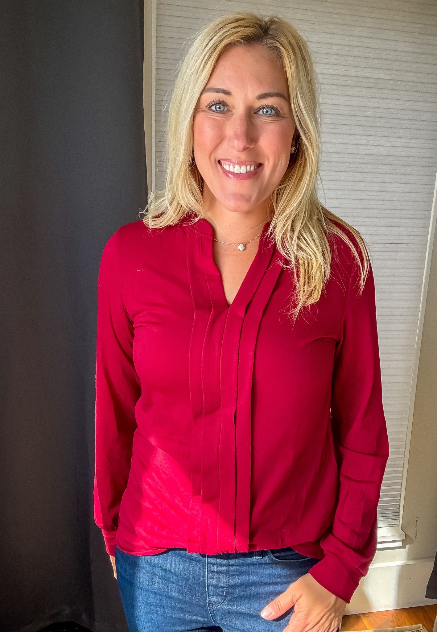 Love how this top instantly dresses up jeans—effortless but polished. A little pop of red that feels perfect for work or a night out!