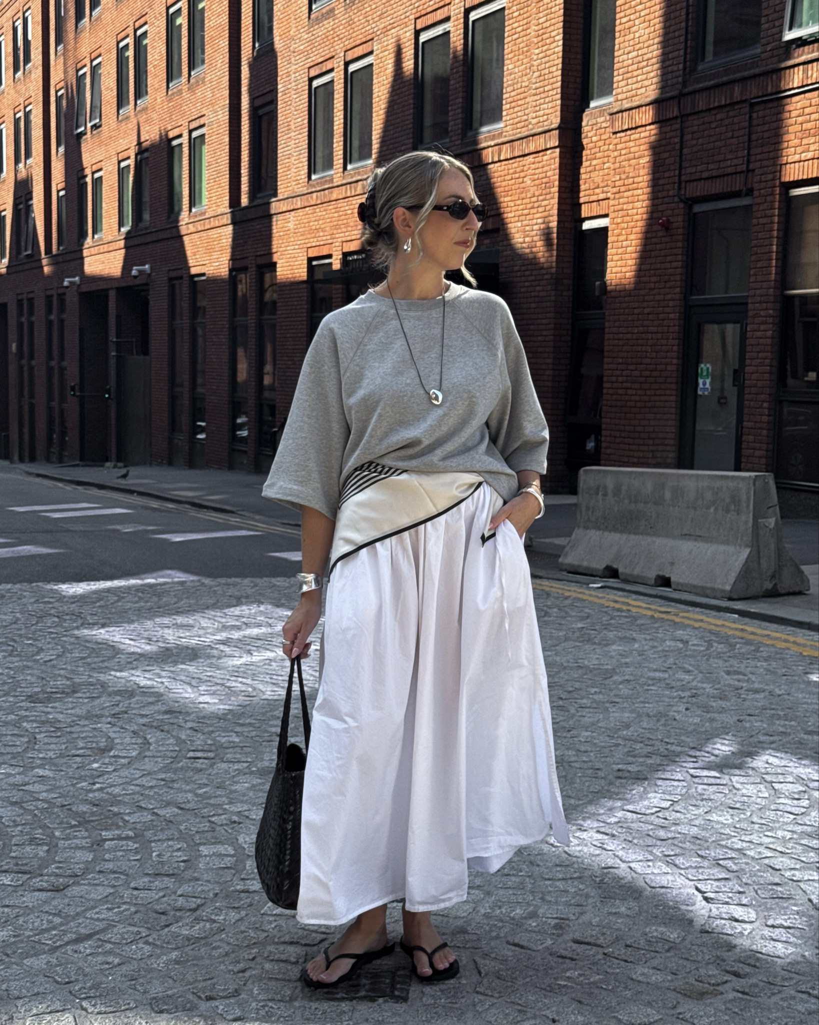 Using a silk scarf as a belt 👏🏻🤍 

White skirt, grey sweatshirt, silk scarf, transitional outfit, flip flops 

#LTKsummer #LTKstyletip #LTKuk