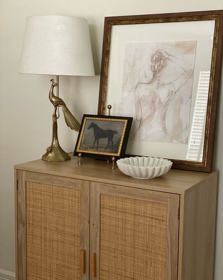 Sophisticate neutral elegance. Rattan cabinet. Light wood cabinet.  Cane cabinet. Wall art. Lamp. Scallop bowl. Neutral home decor  

#LTKhome #LTKstyletip #LTKFind