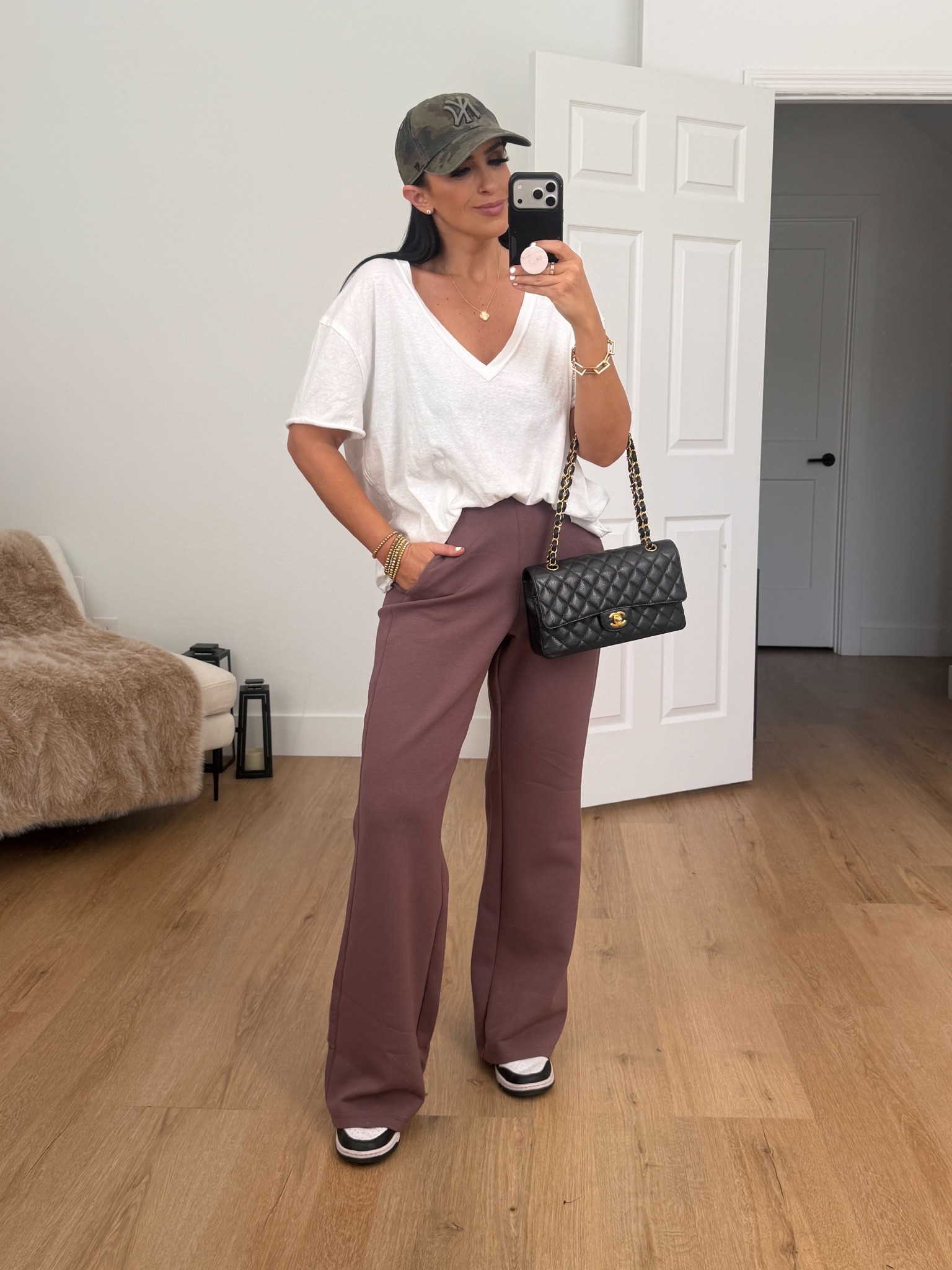 Woman’s V-Neck Cotton T-Shirt from Free people. I’m wearing an extra small. 

Woman’s Nike 24.7 ImpossiblySoft Dri-FIT High-Waisted Loose Flared Pants. I’m wearing a size small. 