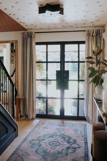 Love adding curtains to a front door to cozy it up! 
I typically hang my curtain rod 5” off the side of the window and 5-8” above 
