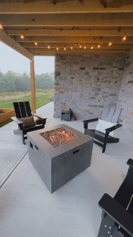 Outdoor patio with fire pit, modern Adirondack chairs, strung lights, outdoor pillows, and views for days ✌🏼

#LTKhome #LTKSeasonal #LTKxPrimeDay