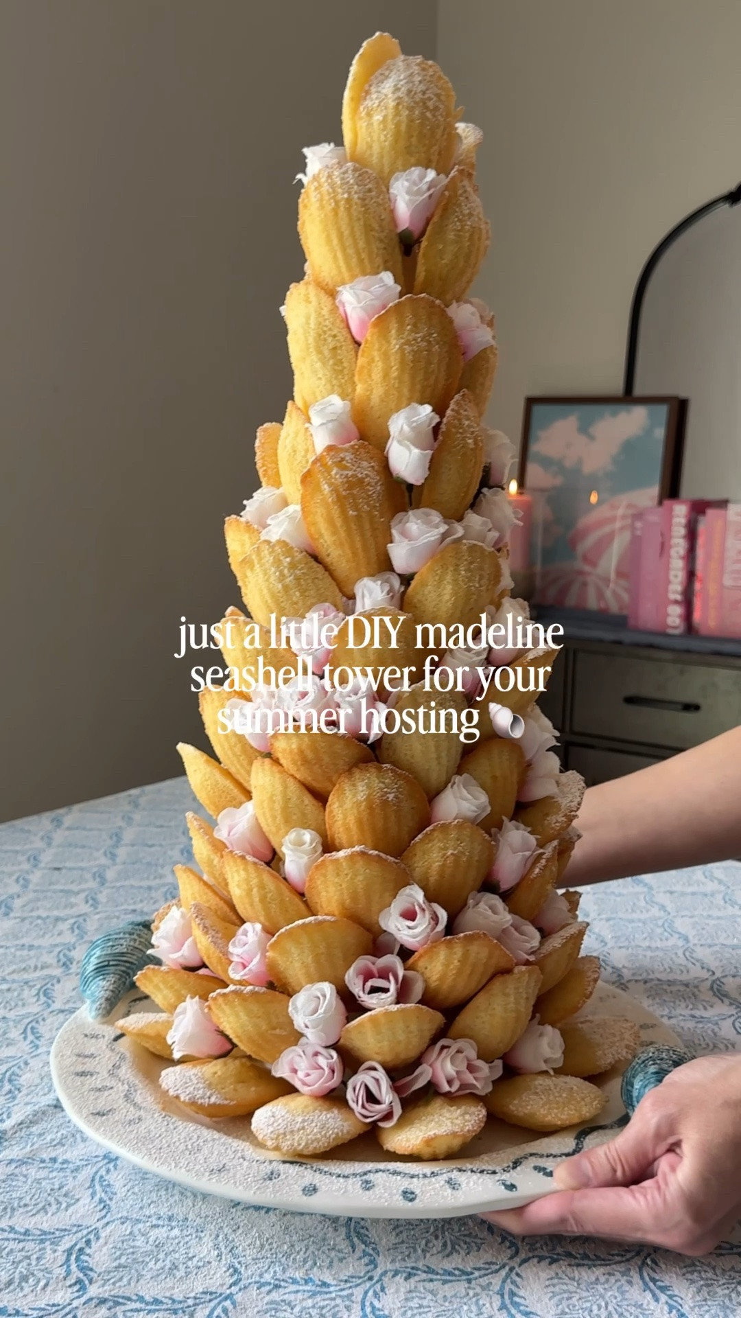 DIY madeline seashell tower 🐚

this might just be the prettiest dessert presentation for summer — super easy (and relaxing) to  make ✨
just wrap your styrofoam cone with plastic wrap and use tooth picks to attach madeline cookies, layer in faux florals of your choice and sprinkle with powdered sugar (optional) 😊
I’m obsessed with how this turned out — it will make such a statement at your next summer gathering  🌸
P.S. I used 84 madelines for this but you could totally buy a smaller size cone too

#LTKSeasonal #LTKHome