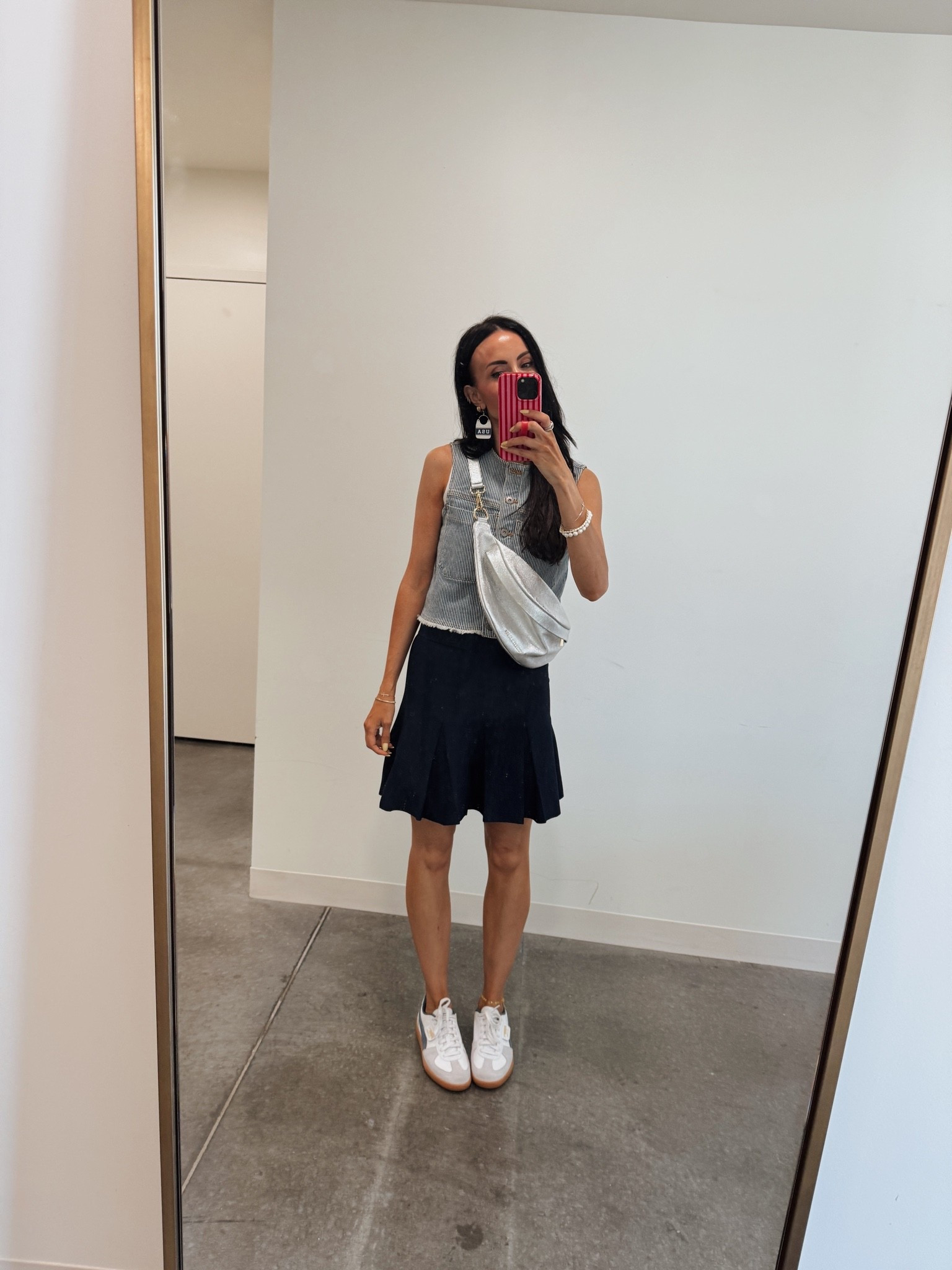 Simple navy skirt and railroad stripe vest. Pairs well with any red white and blue accessories. This silver belt bag is also so unique and great for summer outfits. Perfect for Memorial Day and Fourth of July 🇺🇸