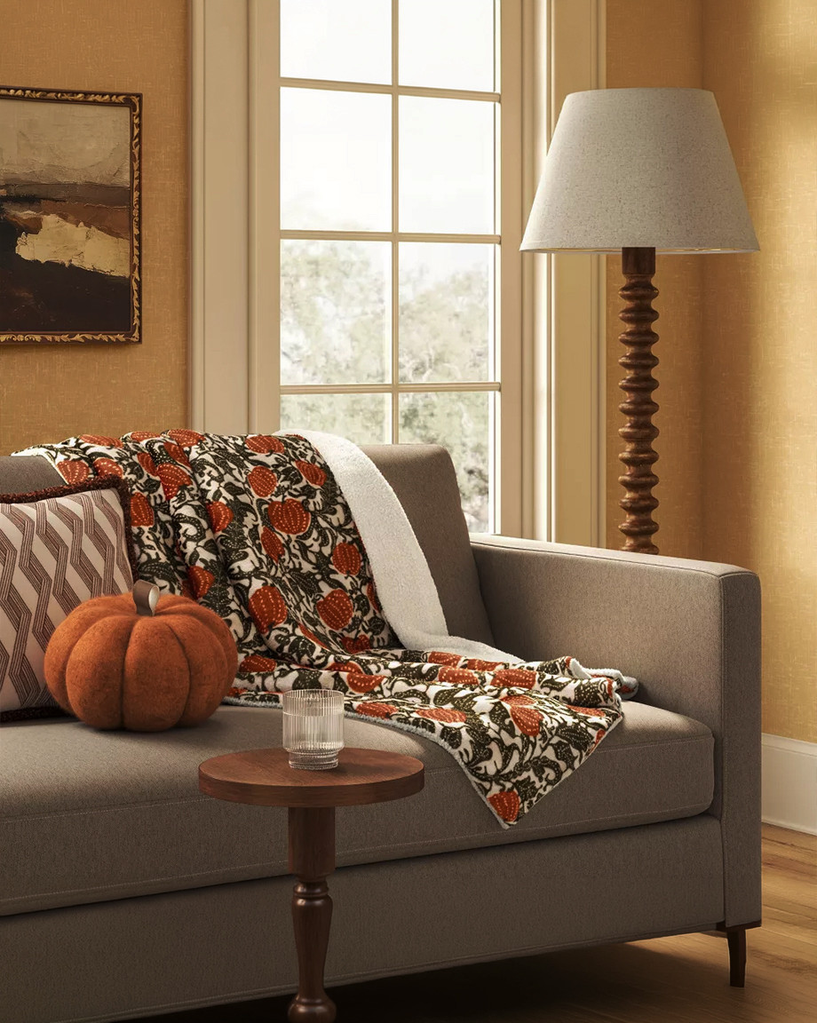 This is the throw that makes a couch look like a whole fall moment. Botanical pumpkin print on one side, soft faux-shearling reverse on the other, so it's just as cozy as it is decorative. Drape it over the arm of a neutral sofa for instant texture and color, or fold it at the foot of the bed for the season. Styles easily with a velvet pumpkin, patterned throw pillows, and warm wood accents for that layered, lived-in autumn look. 

 #LTKSeasonal #LTKHome