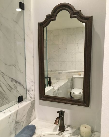 Arched medicine cabinet, California Spanish style bathroom decor, unique accent piece enhancing style. Hard to find, linked item is similar. Calcutta Gold Marble bathroom (tile linked).  

#LTKhome #LTKstyletip #LTKfamily